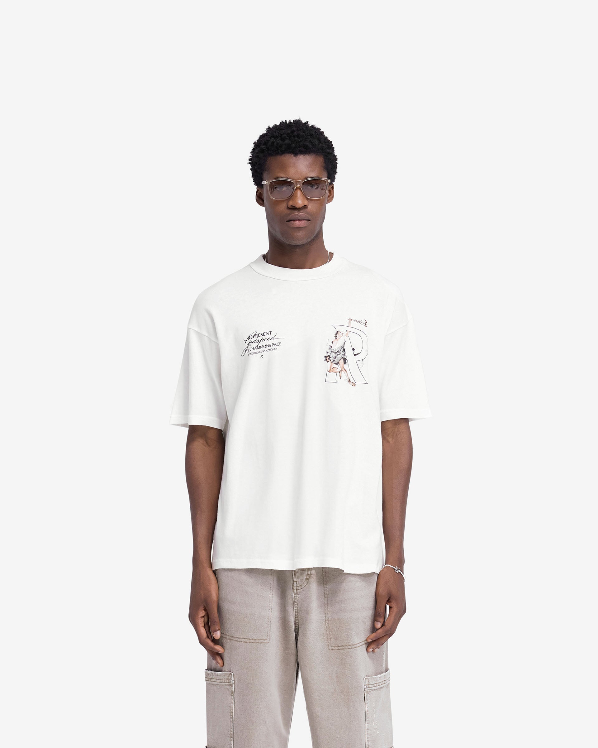 Man wearing an oversized white t-shirt on a plain white background | Hermes T-Shirt in Flat White | Oversized t-shirt with screen print graphic | FW24 T-Shirts | Represent Clo