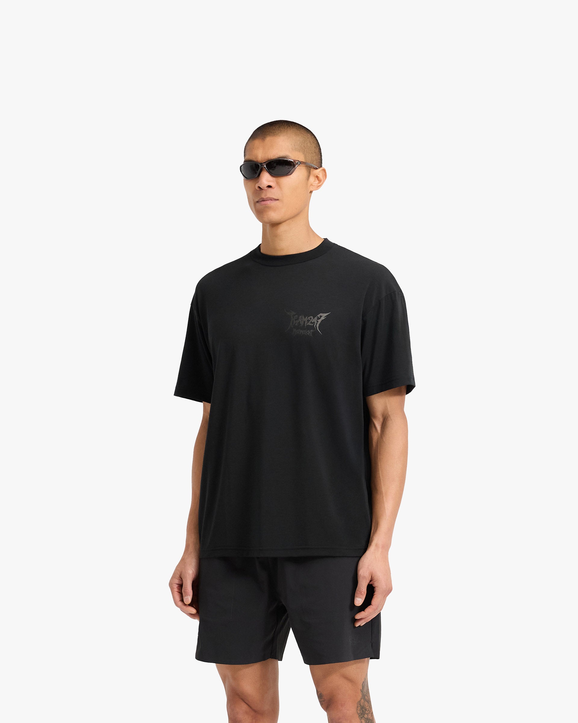 Man wearing an oversized black t-shirt on a plain white background | Team 247 X END Oversized T-Shirt in Jet Black | T-Shirt with Drirelease fabric and 247 x END branding | 247 T-Shirts | Represent Clo