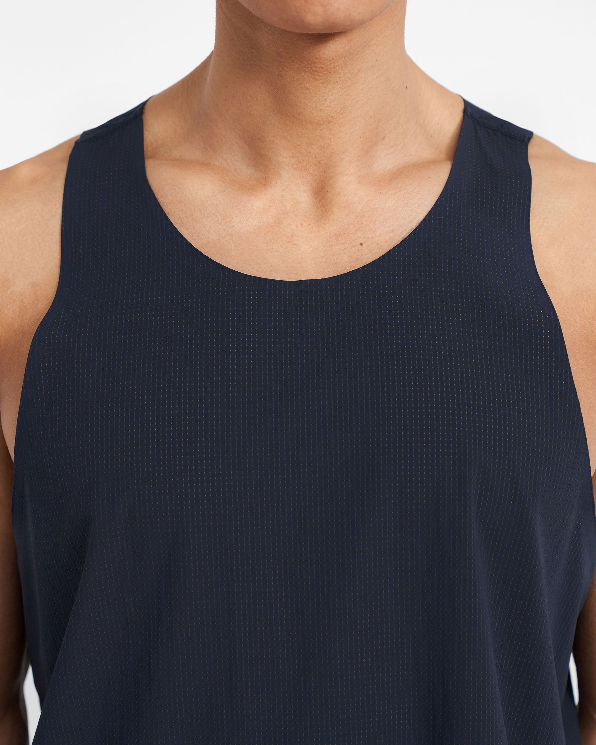 Man wearing a navy training vest on a plain white background | 247 Singlet in Navy | Perforated singlet with bonded hems | 247 T-Shirts | Represent Clo