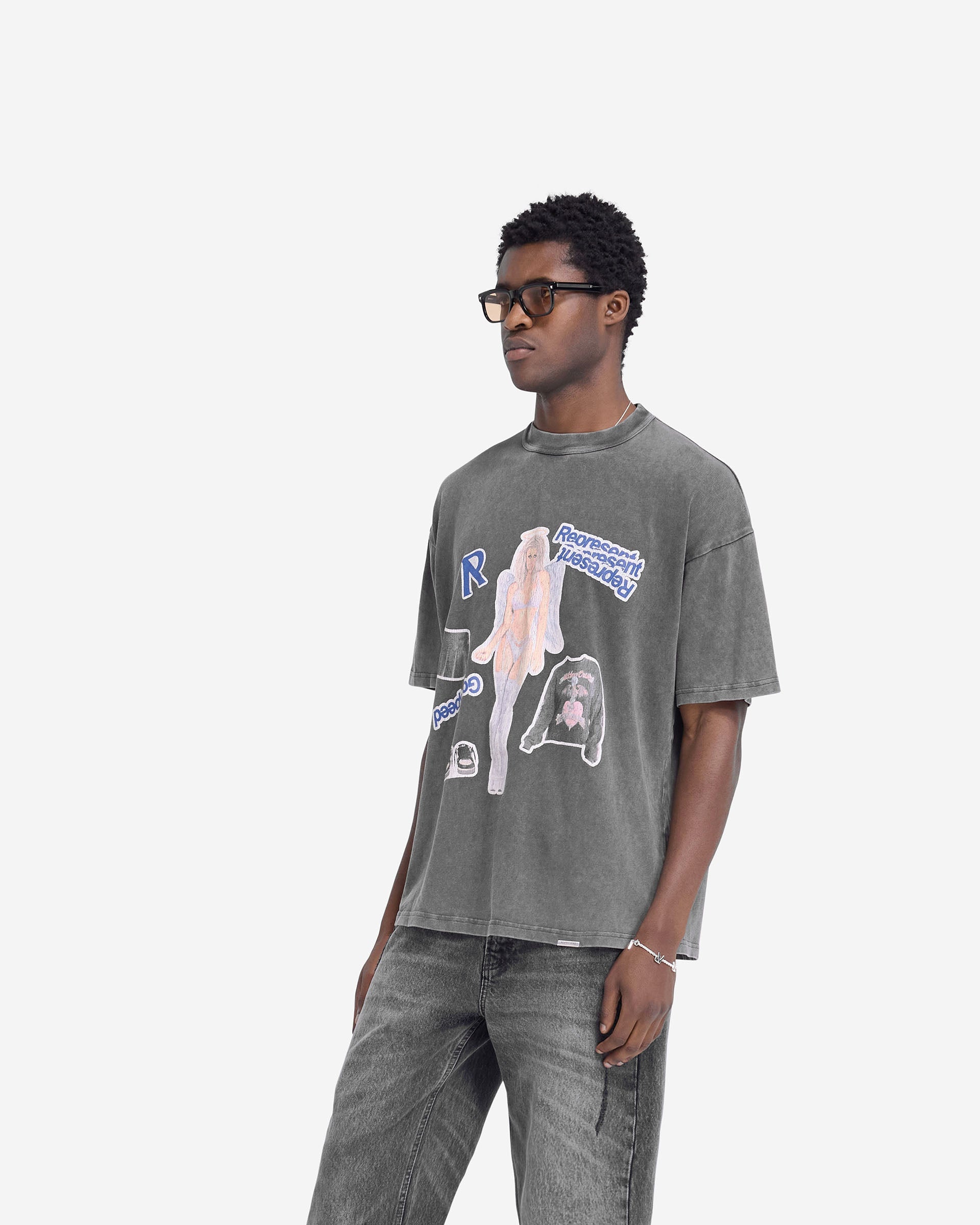 Man wearing a grey t-shirt with a cracked graphic print on a plain white background | Question Your Innocence T-Shirt in Vintage Grey | Oversized cotton t-shirt | FW24 T-Shirts | Represent Clo