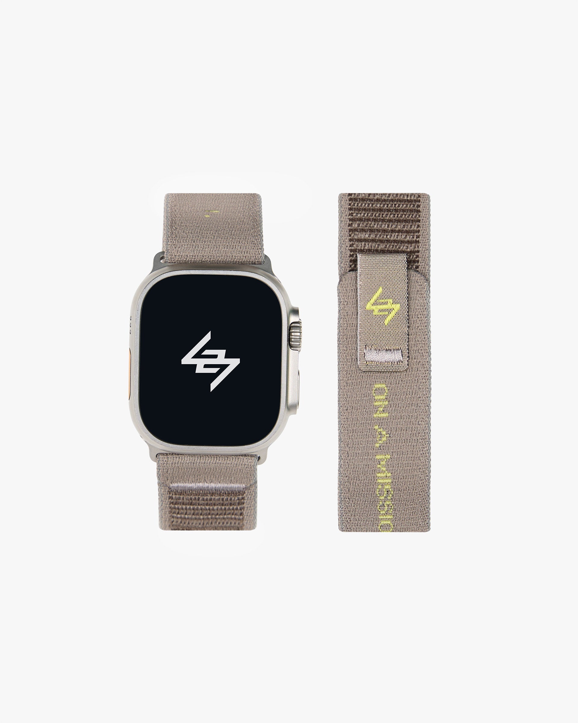 Back product image of a mens grey Apple watch strap on a plain white background | 247 Apple Watch Strap in Pebble | Nylon weave strap with velcro fastener and jacquard branding | 247 Accessories | Represent Clo