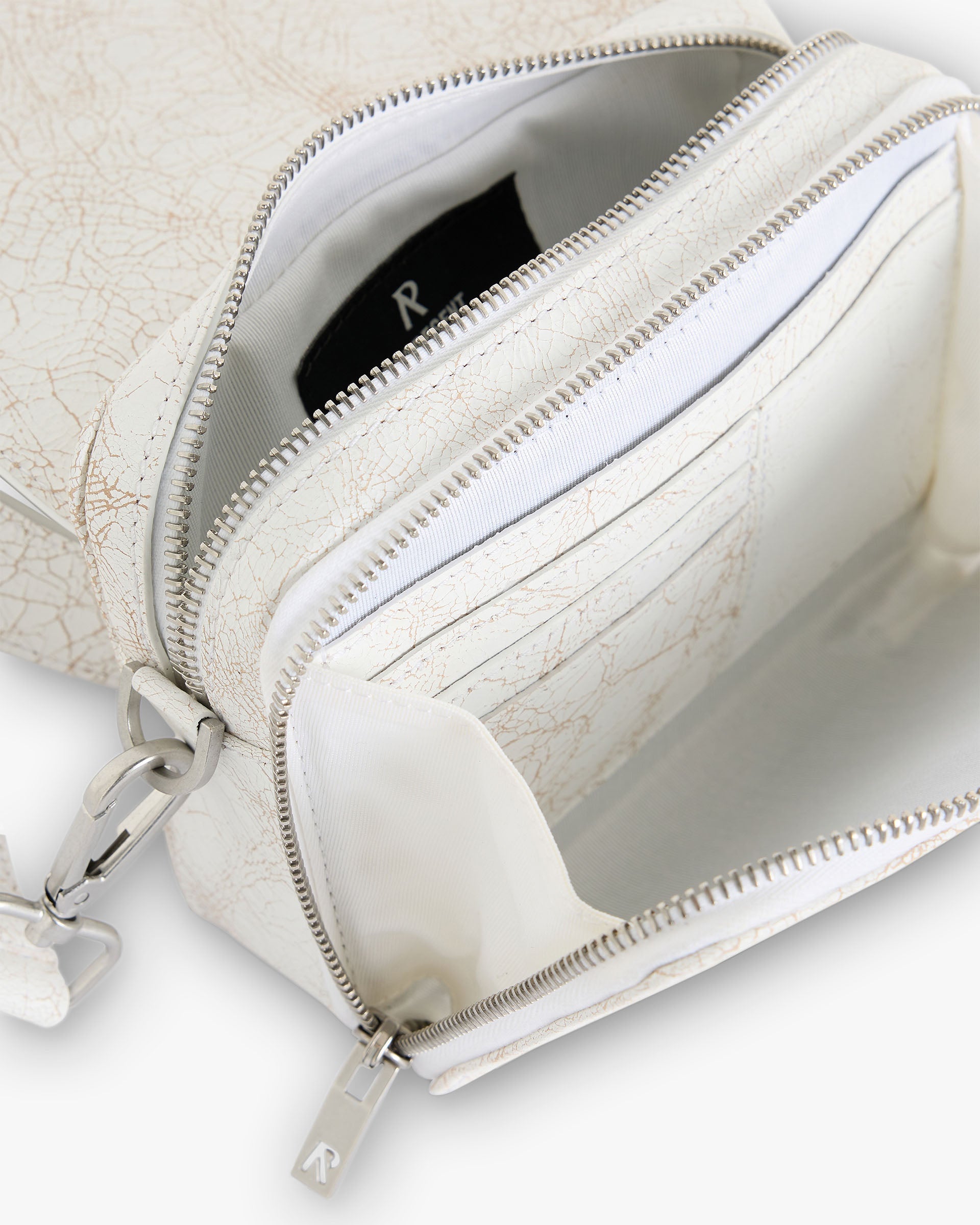 Back product image of a mens white cross body bag on a plain white background | Cracked Leather Cross Body Bag in Antique White | 100 percent cracked leather bag with adjustable strap | SC24 Accessories | Represent Clo
