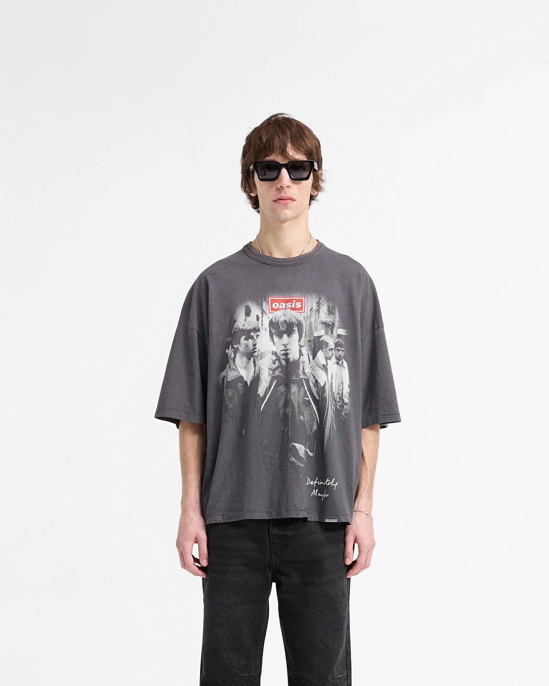 Man wearing a grey t-shirt on a plain white background | Represent X Oasis Definitely Maybe T-Shirt in Washed Black | Oversized t-shirt with iconic Oasis graphics | FW24 T-Shirts | Represent Clo