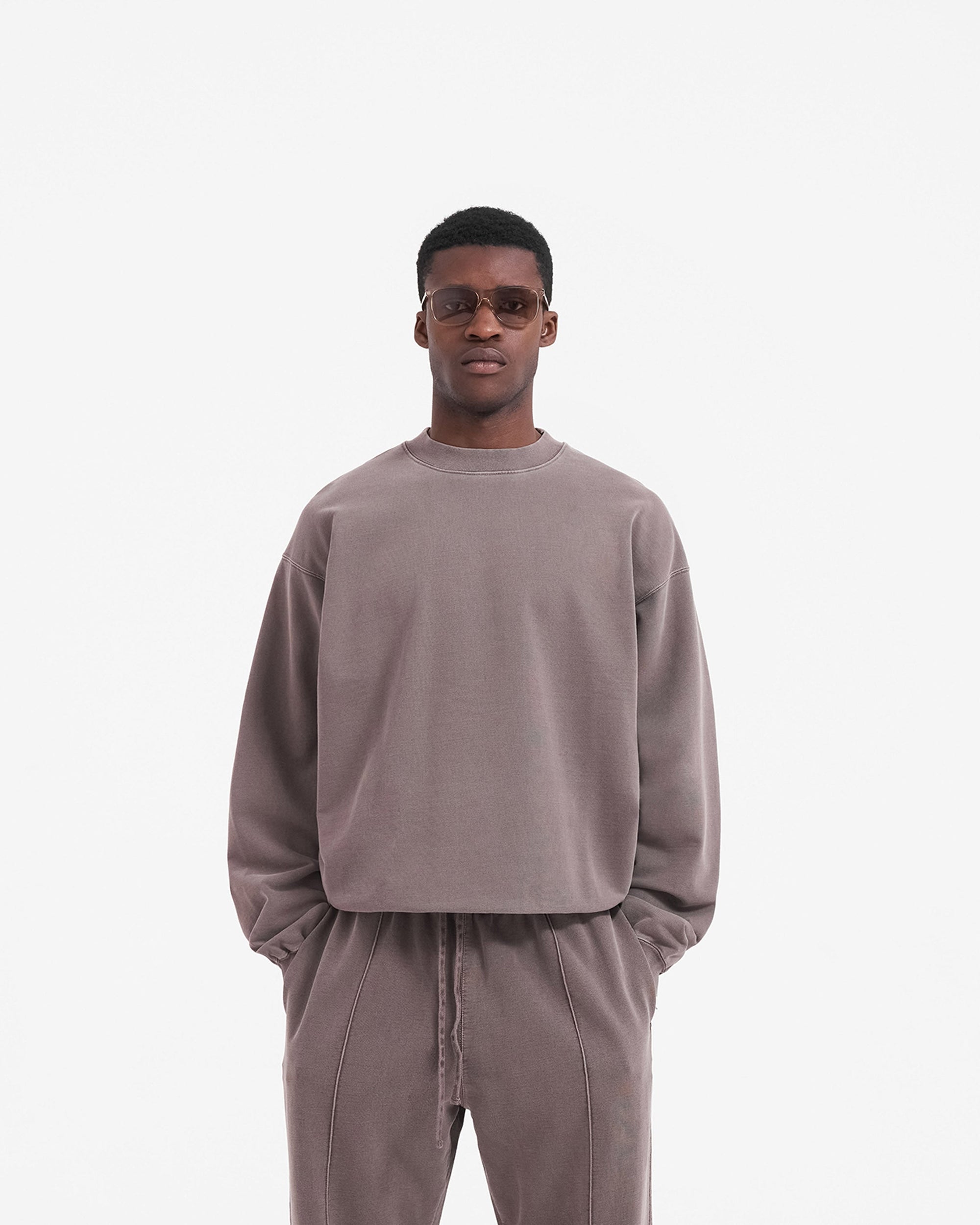 Man wearing a grey sweater on a plain white background | Initial Sweater in Fog | Slightly oversized fit sweater with embroidered logo | Initial Sweaters | Represent Clo