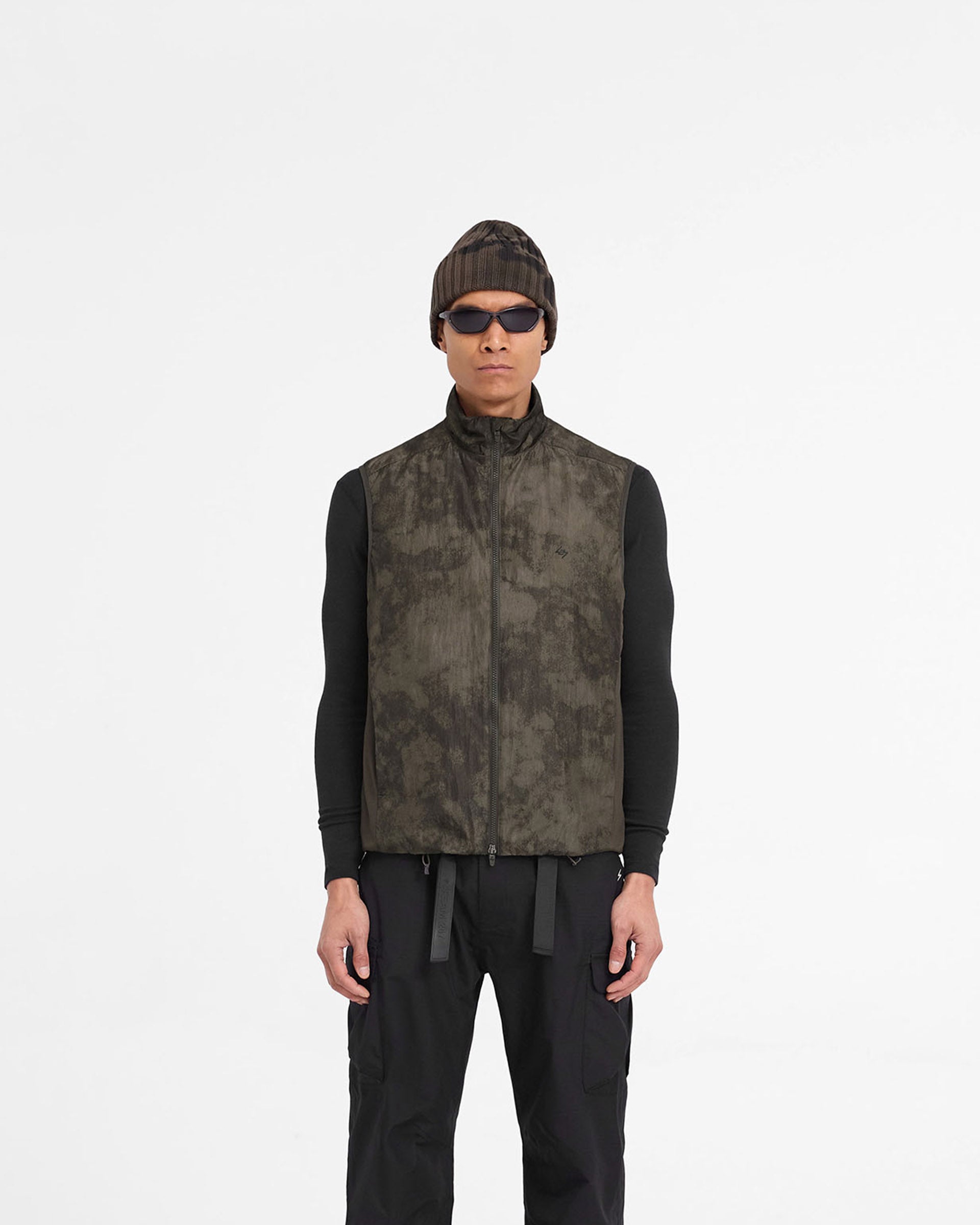 Man wearing a terrain print gilet on a plain white background | Team 247 Insulated Gilet in Terrain | Insulated gilet with adjustable hem and side pockets | 247 Outerwear | Represent Clo