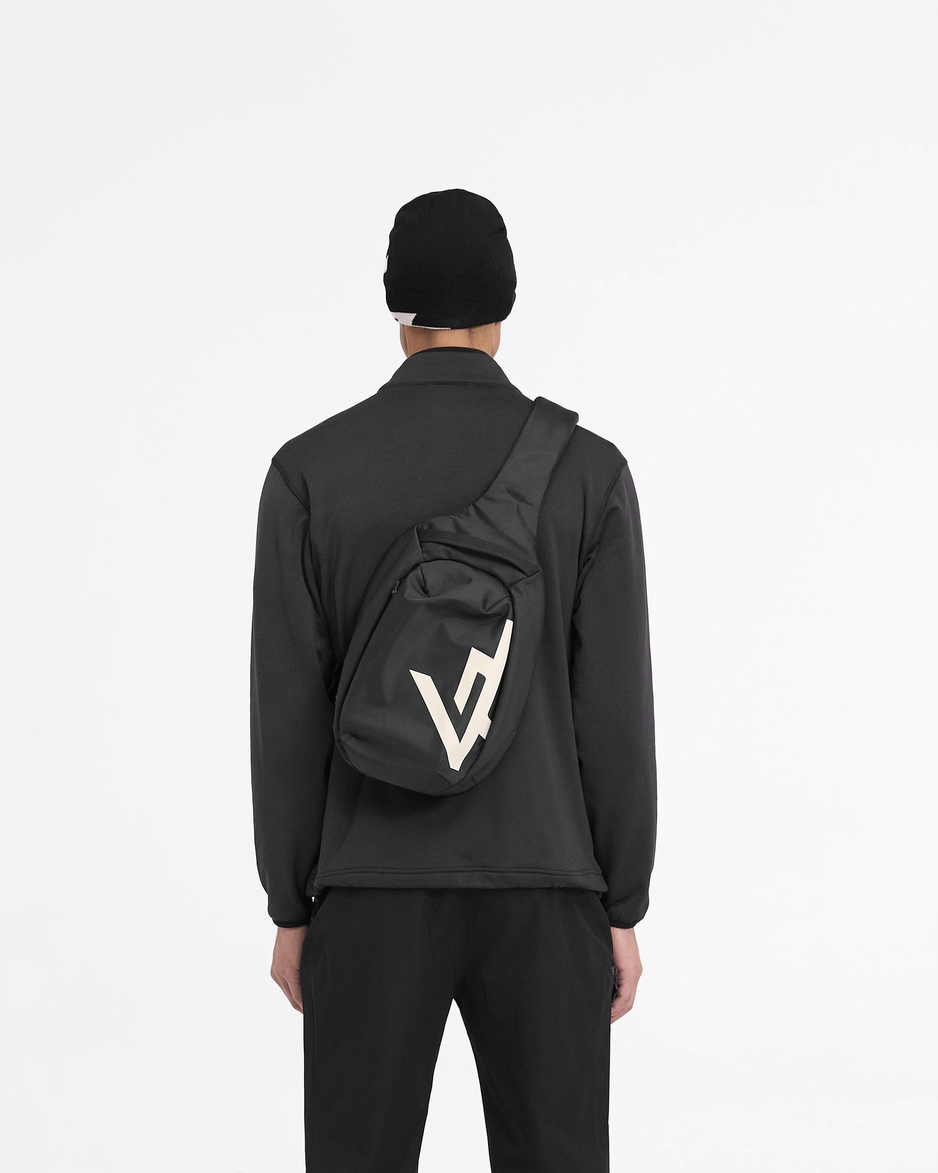 Man wearing a black zip fleece jacket on a plain white background | 247 Full Zip Fleece in Black | Fleece jacket with zip chest pocket and adjustable hem | 247 Outerwear | Represent Clo