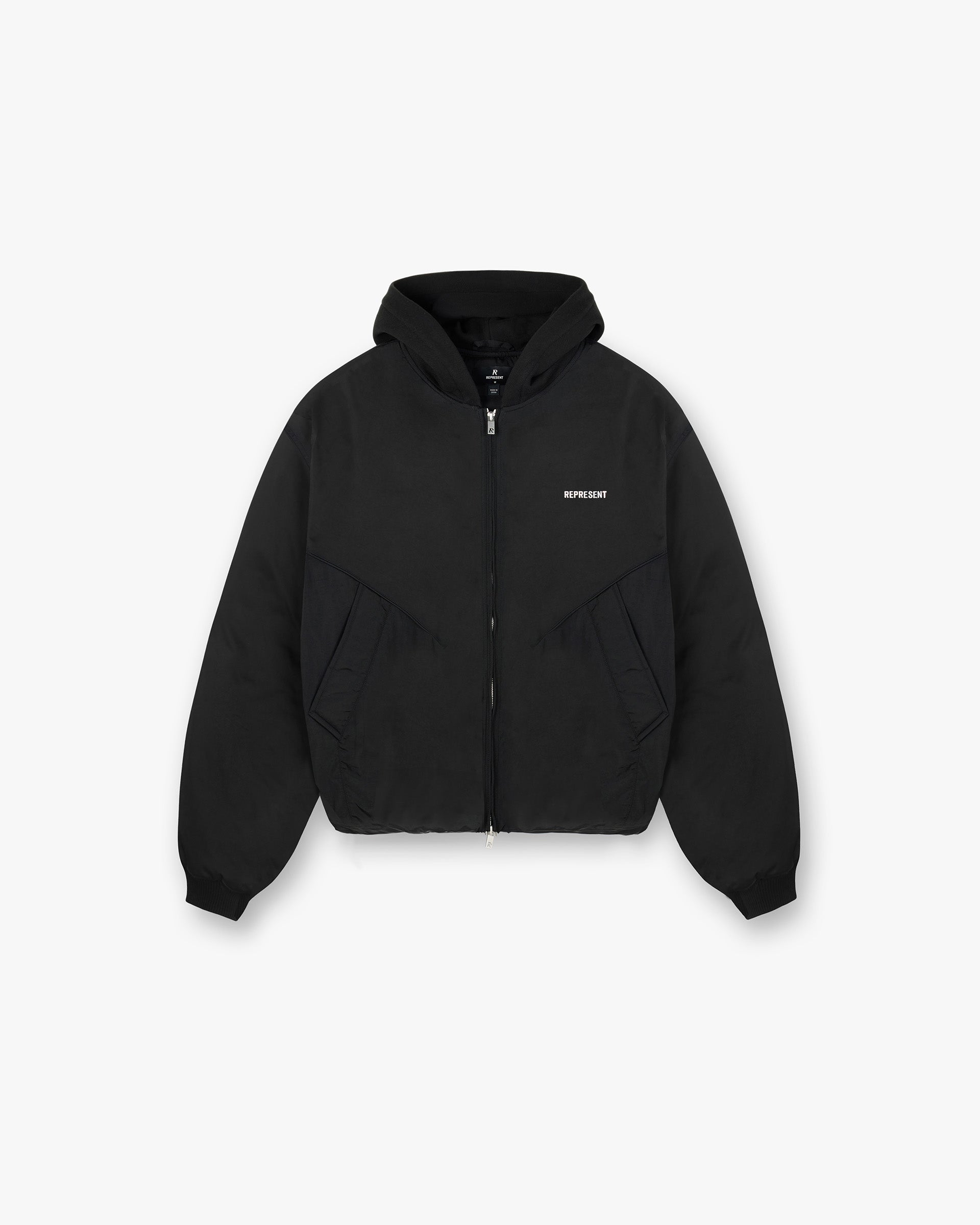 Front product image of a mens black hooded bomber jacket on a plain white background | Nylon Hooded Bomber Jacket in Black | Oversized wadded pullover jacket with elasticated drawstring hem | PRE SS25 Outerwear | Represent Clo