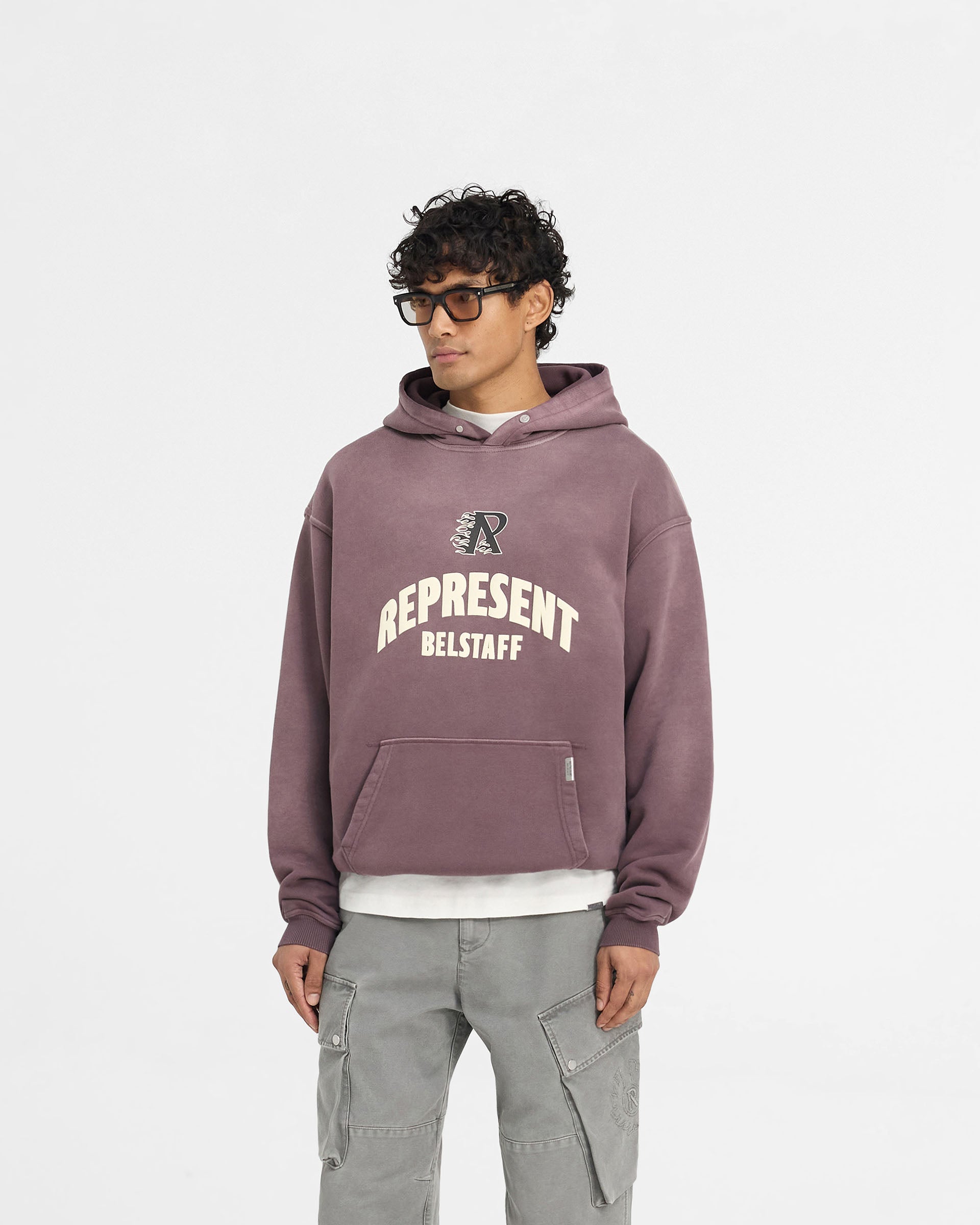 Man wearing an oversized plum hoodie on a plain white background | Represent X Belstaff Flame Phoenix Hoodie in Plum | Heavyweight hoodie with unique logos | Exclusives Hoodies | Represent Clo