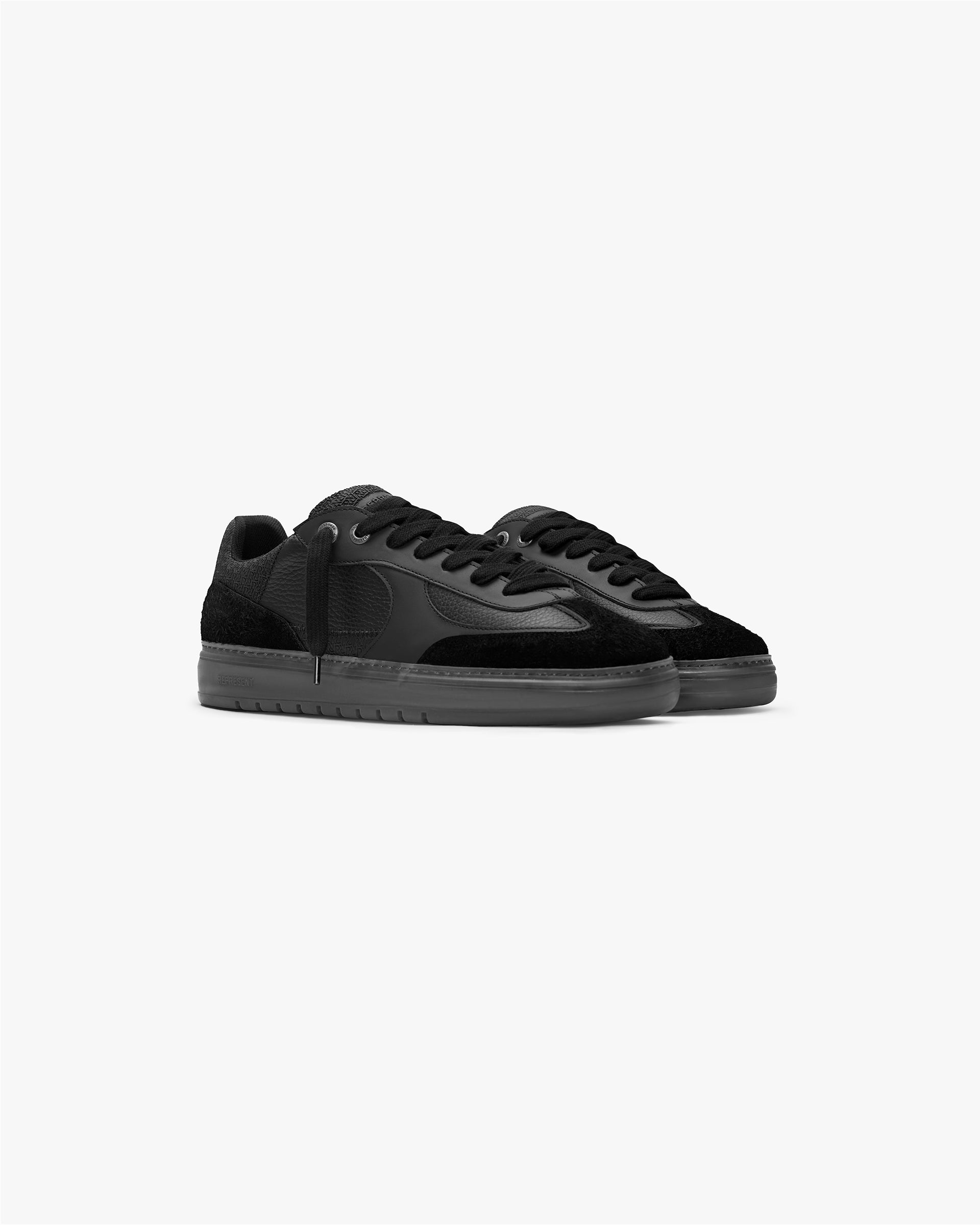 Back product image of a mens black sneaker on a plain white background | Virtus in Off Black | Minimalist sneaker with leather and suede upper | FW23 Footwear | Represent Clo