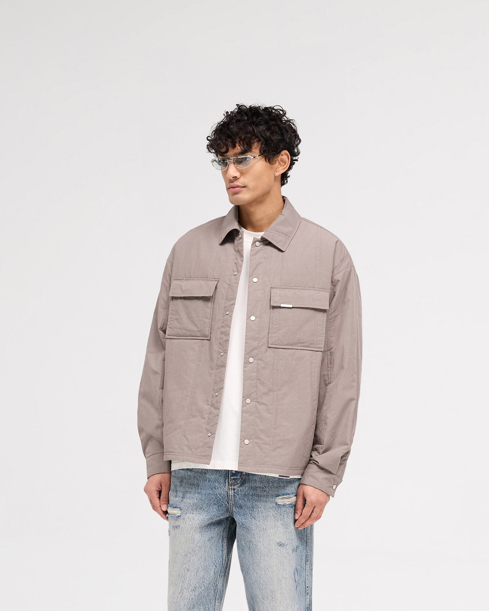 Back product image of a mens grey quilted overshirt on a plain white background | Quilted Overshirt in Mid Grey | Overshirt with twin needle vertical quilting and light wadding | SS25 Shirts | Represent Clo