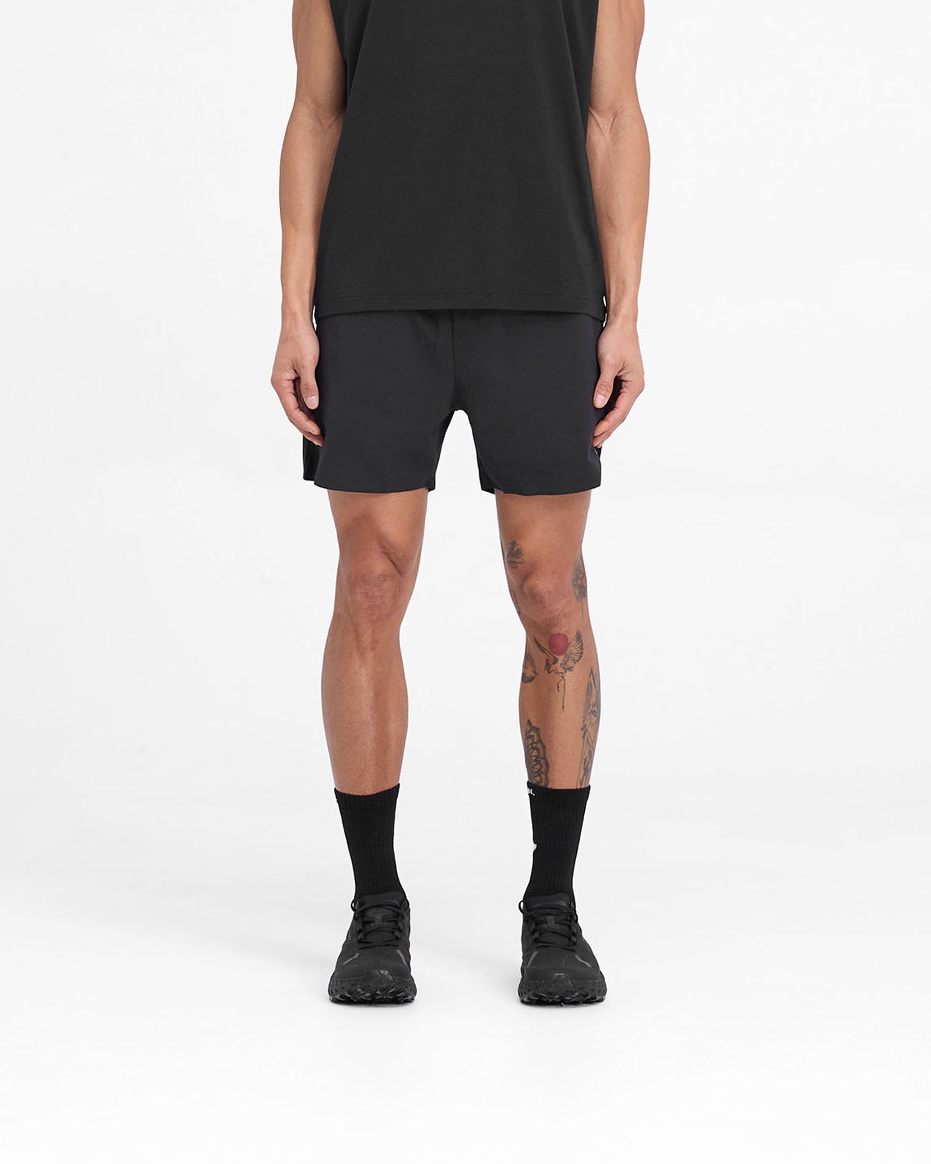 Man wearing black training shorts on a plain white background | Team 247 Fused Shorts in Black | Shorts with branded waistband and 4-way stretch | 247 Shorts | Represent Clo