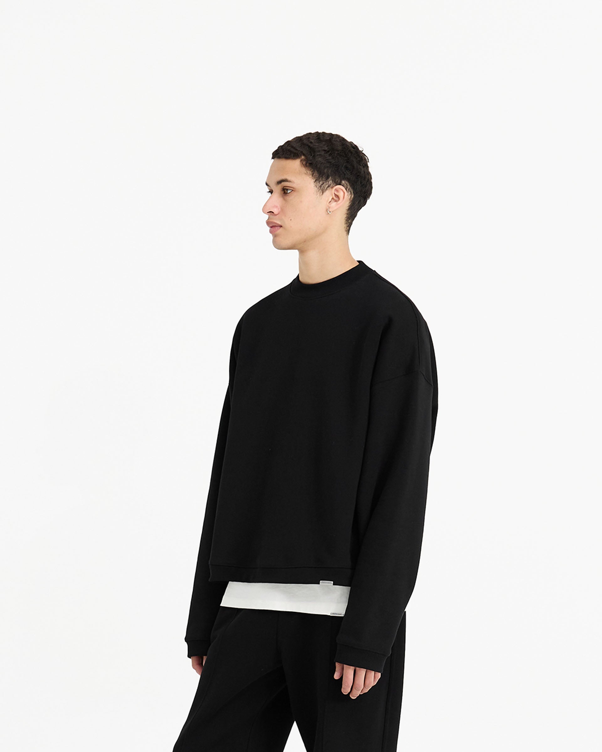 Back product image of a mens black sweater on a plain white background | Initial Boxy Sweater in Black | Boxy fit sweater with embroidered Initial and Represent metal bar | Initial Sweaters | Represent Clo