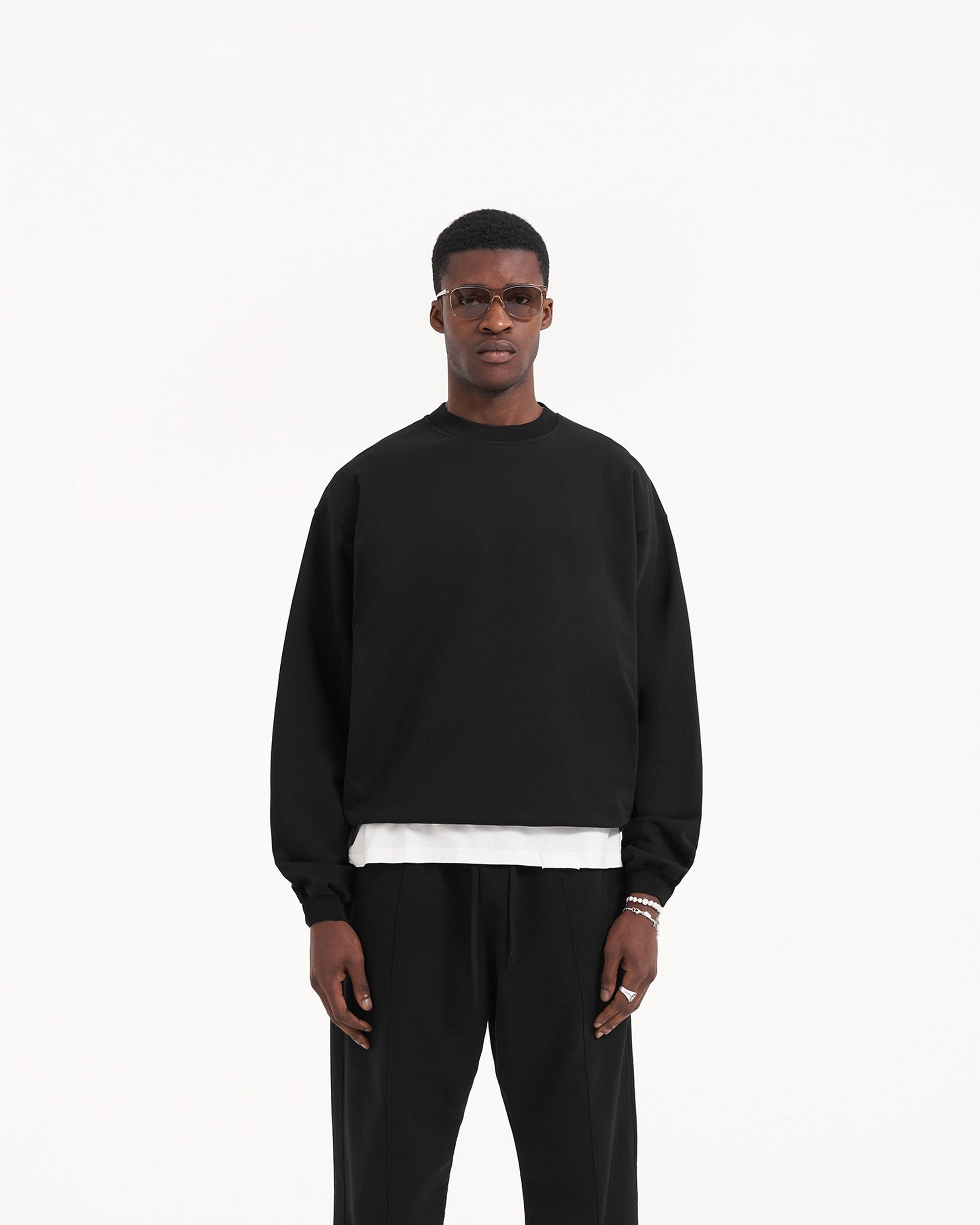 Back product image of a mens black sweater on a plain white background | Initial Sweater in Jet Black | Sweater with single stitch detailing and embroidered logo | Initial Sweaters | Represent Clo