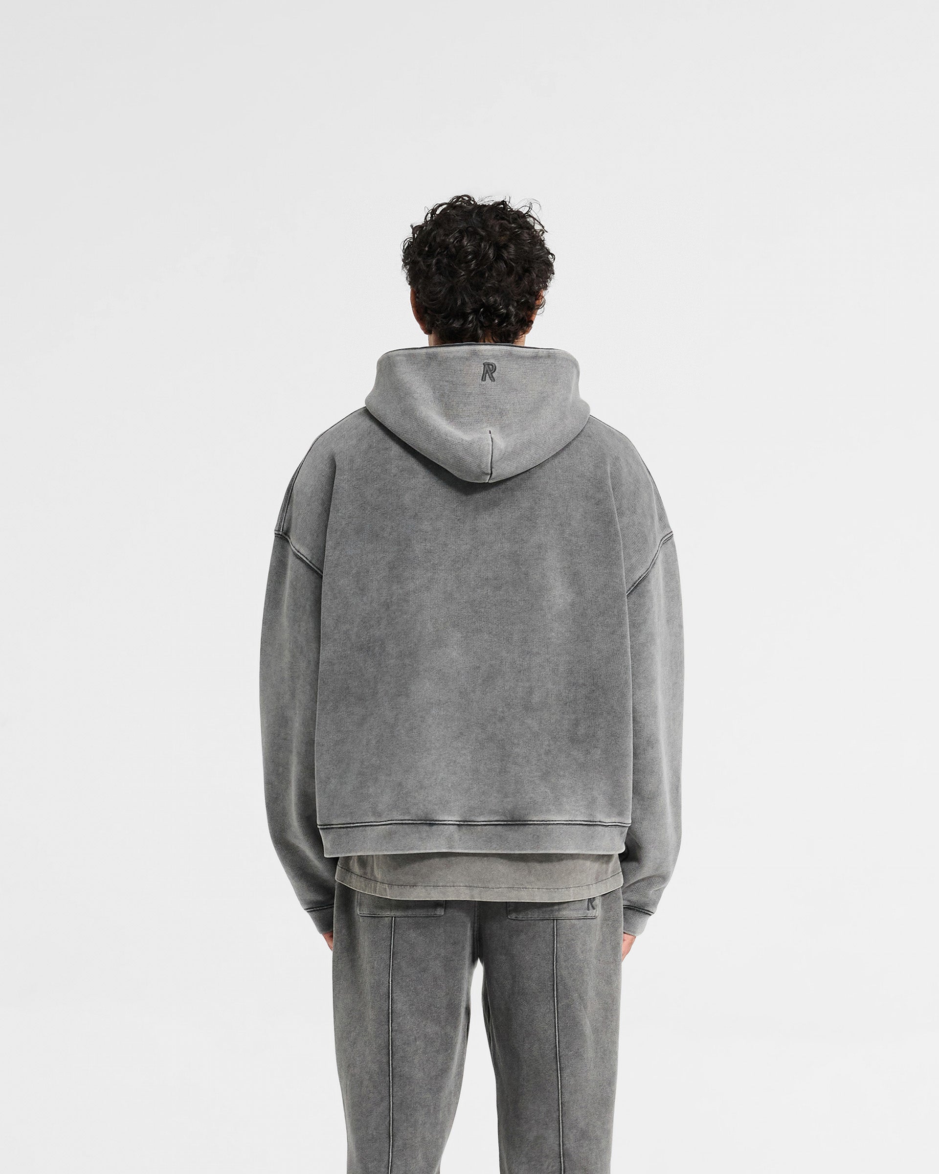 Man wearing an oversized grey hoodie on a plain white background | Initial Boxy Hoodie in Vintage Grey | Super cropped boxy hoodie with brushed fleece | Initial Hoodies | Represent Clo