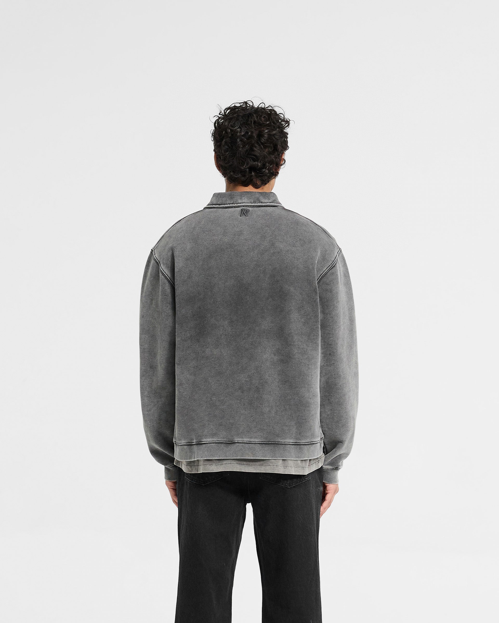 Man wearing a grey quarter zip sweater on a plain white background | Initial Boxy Quarter Zip in Vintage Grey | Oversized boxy fit sweater with cropped body and RiRi zip | Initial Sweaters | Represent Clo
