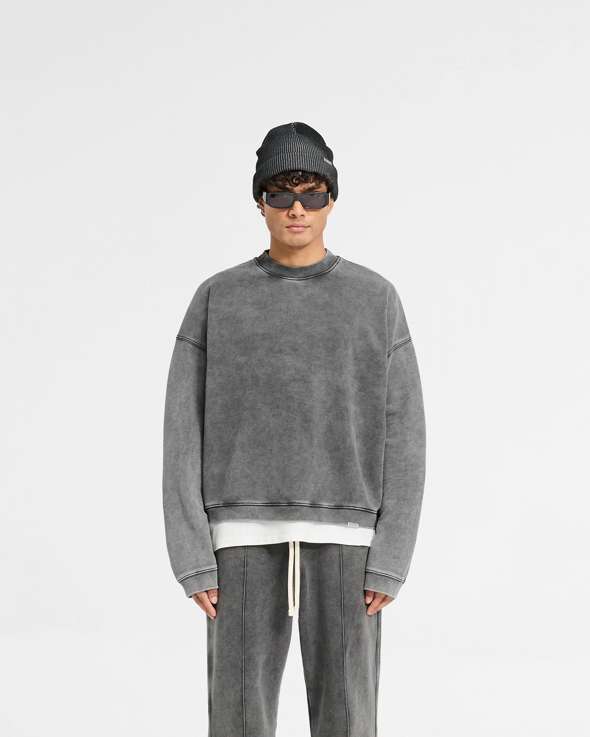 Man wearing a grey oversized boxy sweater on a plain white background | Initial Boxy Sweater in Vintage Grey | Oversized super cropped sweater with dropped shoulders | Initial Sweaters | Represent Clo
