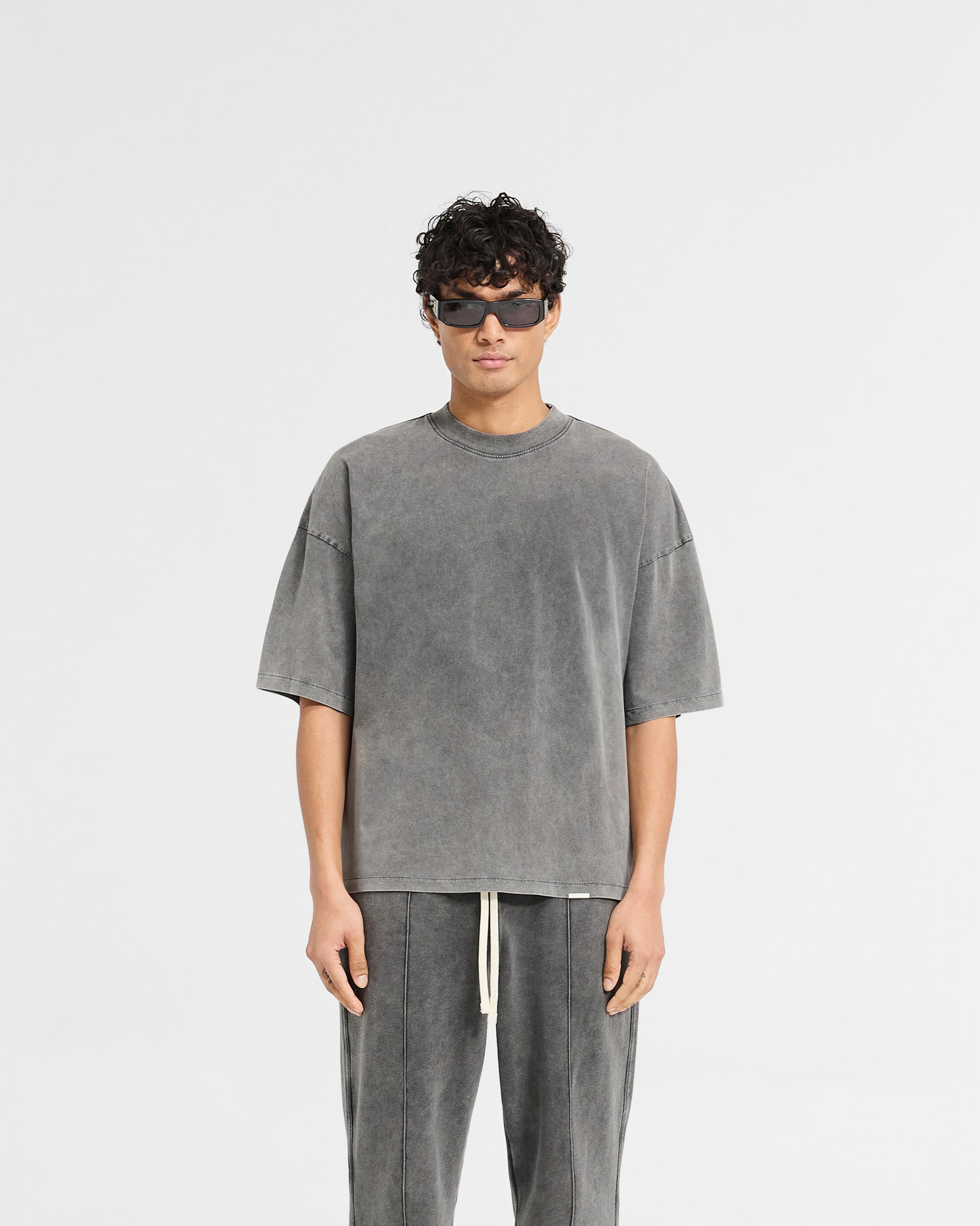 Man wearing a grey boxy t-shirt on a plain white background | Initial Boxy T-Shirt in Vintage Grey | Super oversized cropped fit t-shirt | Initial T-Shirts | Represent Clo