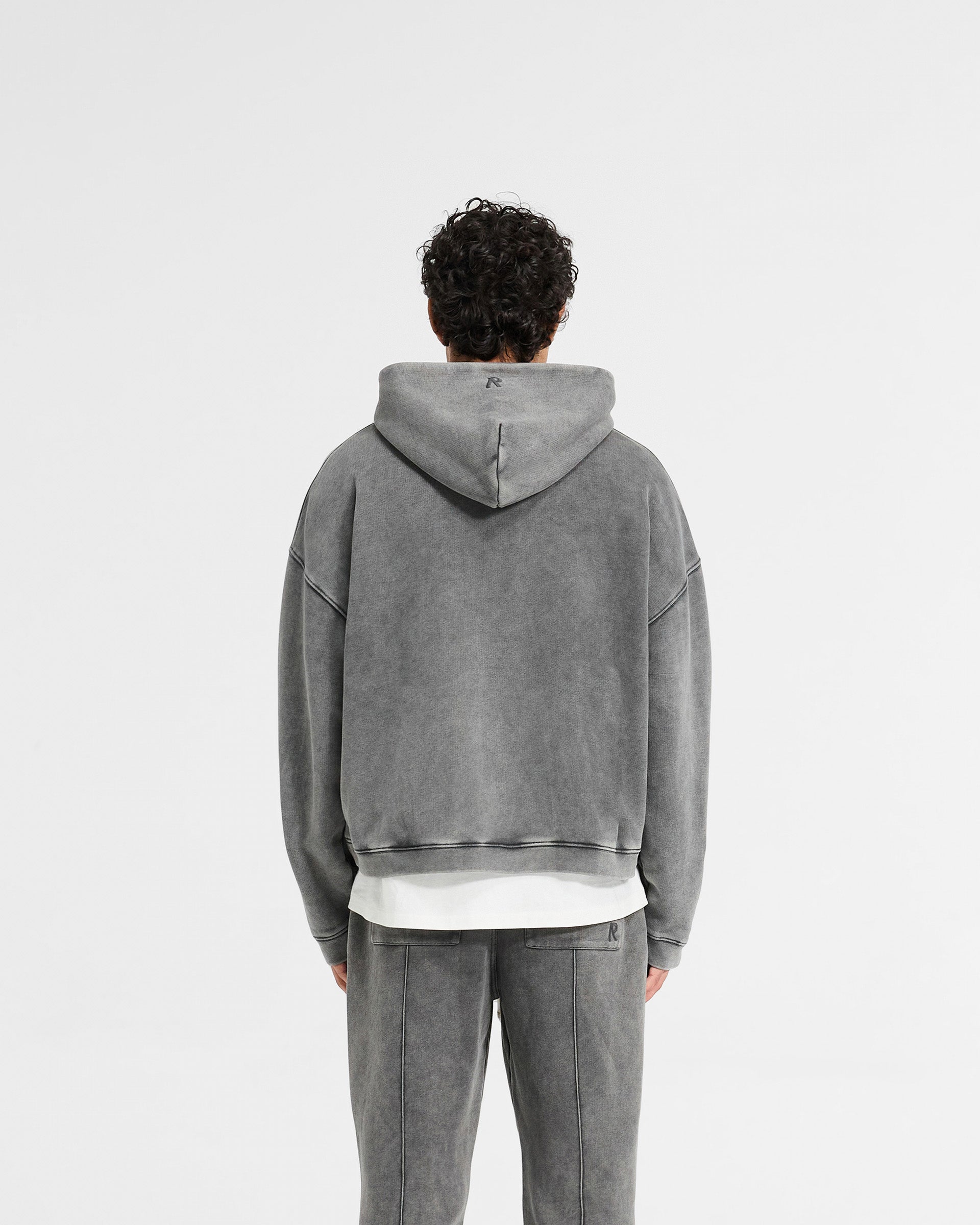 Man wearing a grey boxy zip through hoodie on a plain white background | Initial Boxy Zip Through Hoodie in Vintage Grey | Oversized boxy fit with super cropped body | Initial Hoodies | Represent Clo