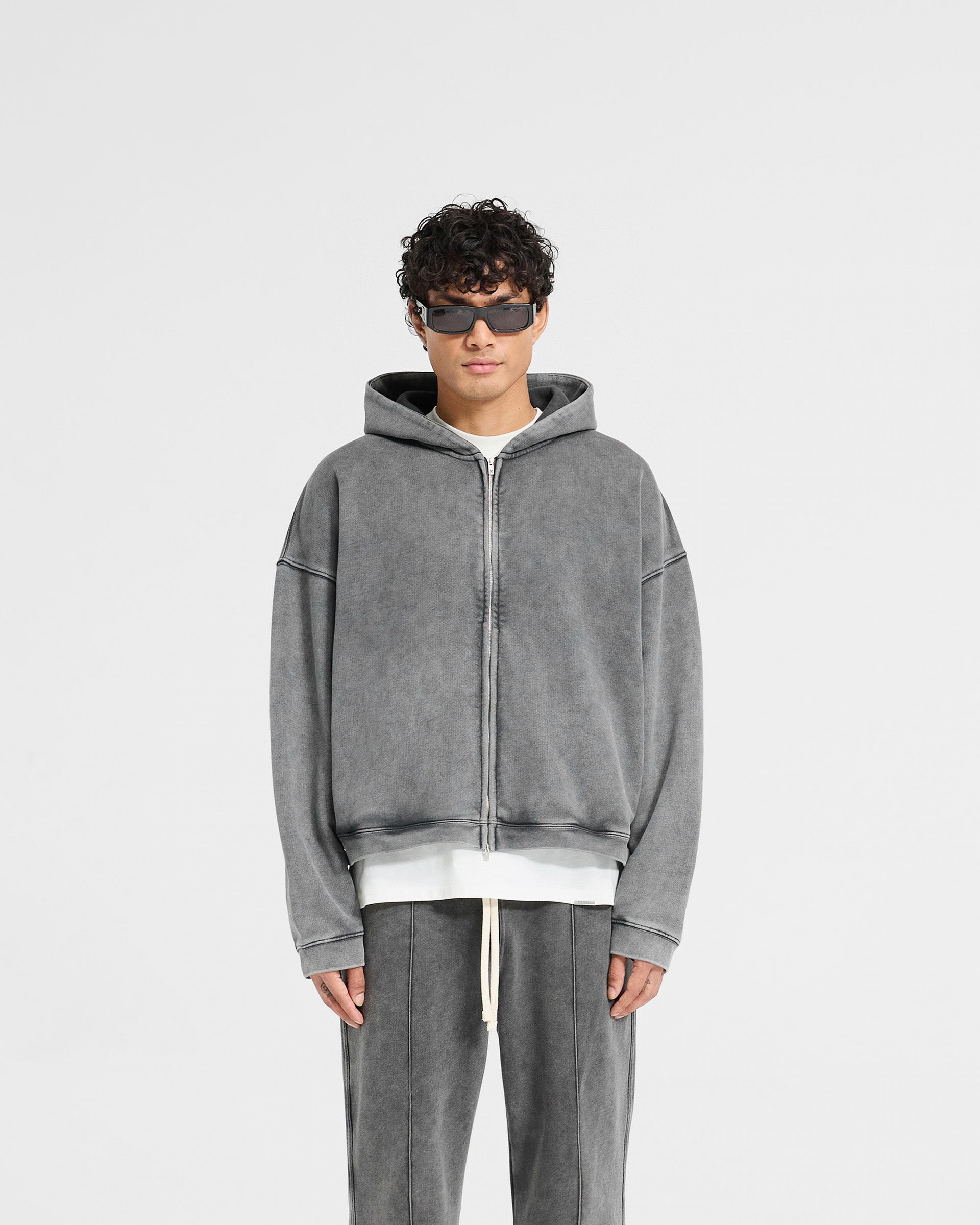 Man wearing a grey zip hoodie on a plain white background | Initial Boxy Zip Through Hoodie in Vintage Grey | Oversized boxy fit zip hoodie with dropped shoulders | Initial Hoodies | Represent Clo