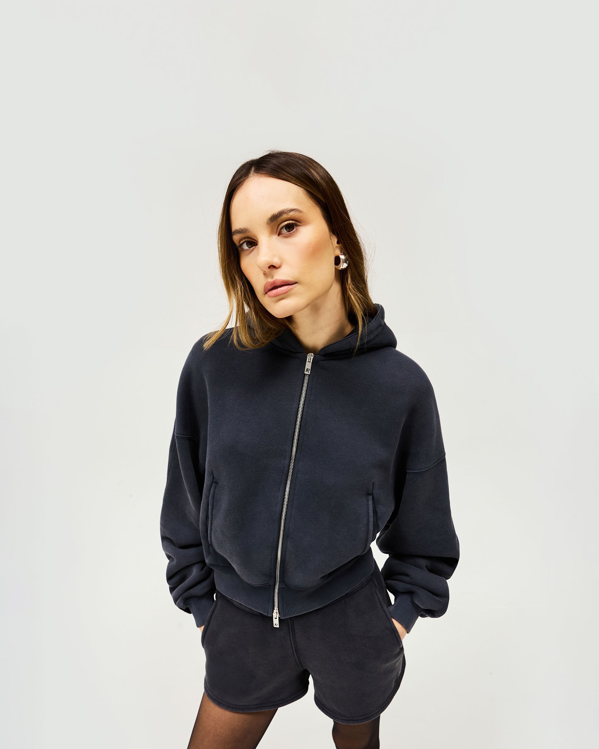Back product image of a womens black cropped hoodie on a plain white background | Initial Oversized Crop Hoodie in Washed Black | Heavyweight cotton cropped hoodie with double ended zipper | Womens Initial Hoodies | Represent Clo