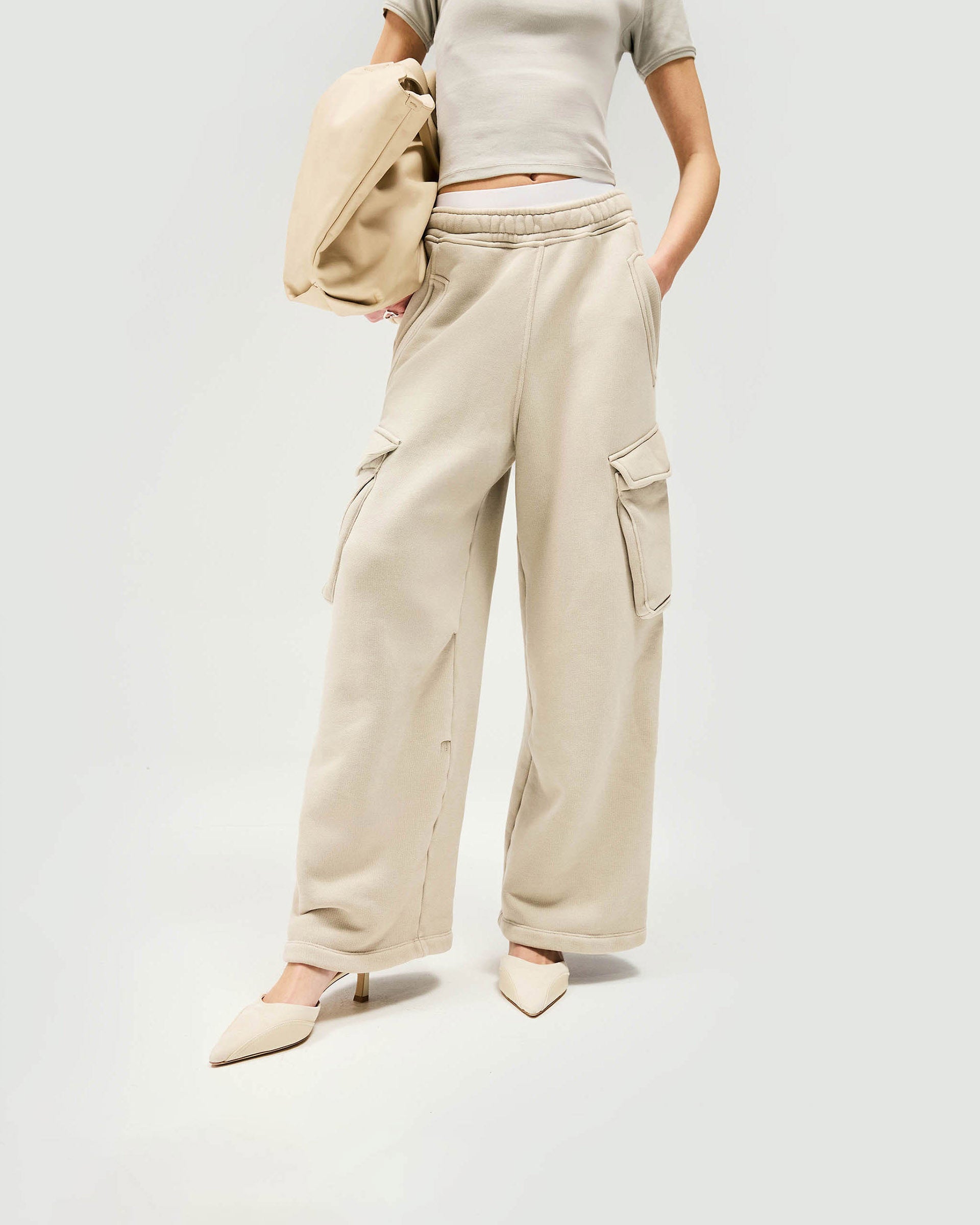 Back product image of womens grey joggers on a plain white background | Initial Cargo Jogger in Storm | Cargo joggers with patch and side entry pockets | Womens Initial Bottoms | Represent Clo