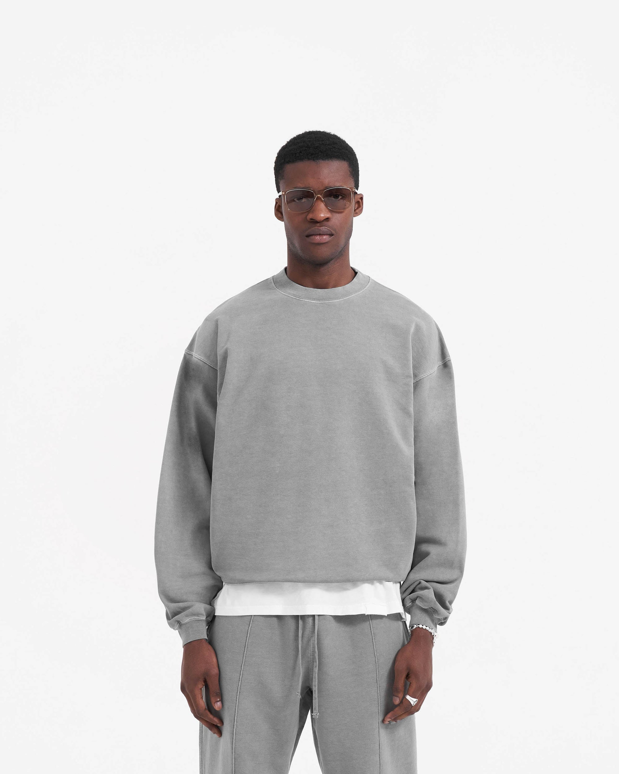 Man wearing a grey sweater on a plain white background | Initial Sweater in Ultimate Grey | Sweater with wide sleeves and boxy fit | Initial Sweaters | Represent Clo