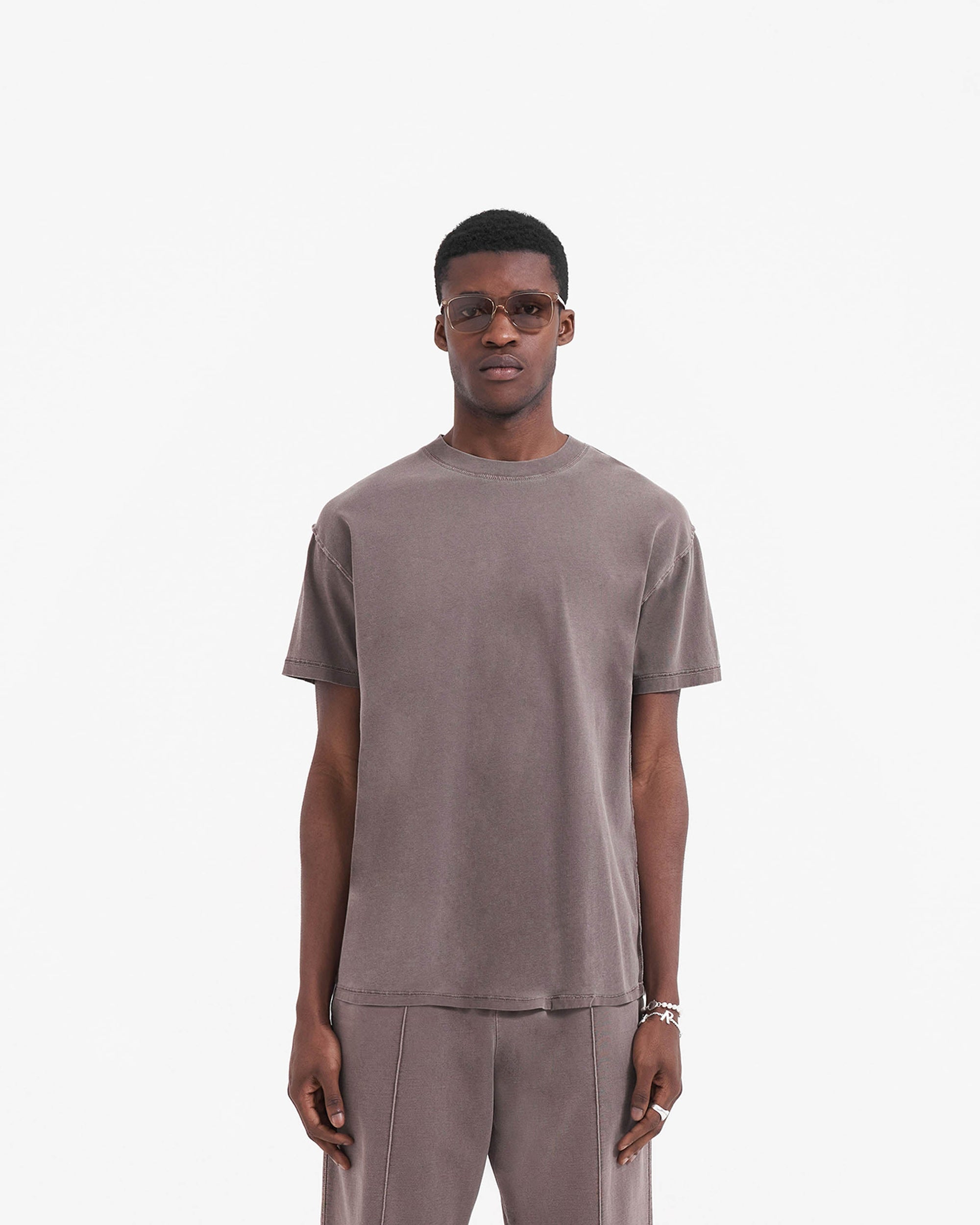 Man wearing a grey oversized t-shirt on a plain white background | Initial T-Shirt in Fog | Oversized t-shirt with external overlock seams | Initial T-Shirts | Represent Clo