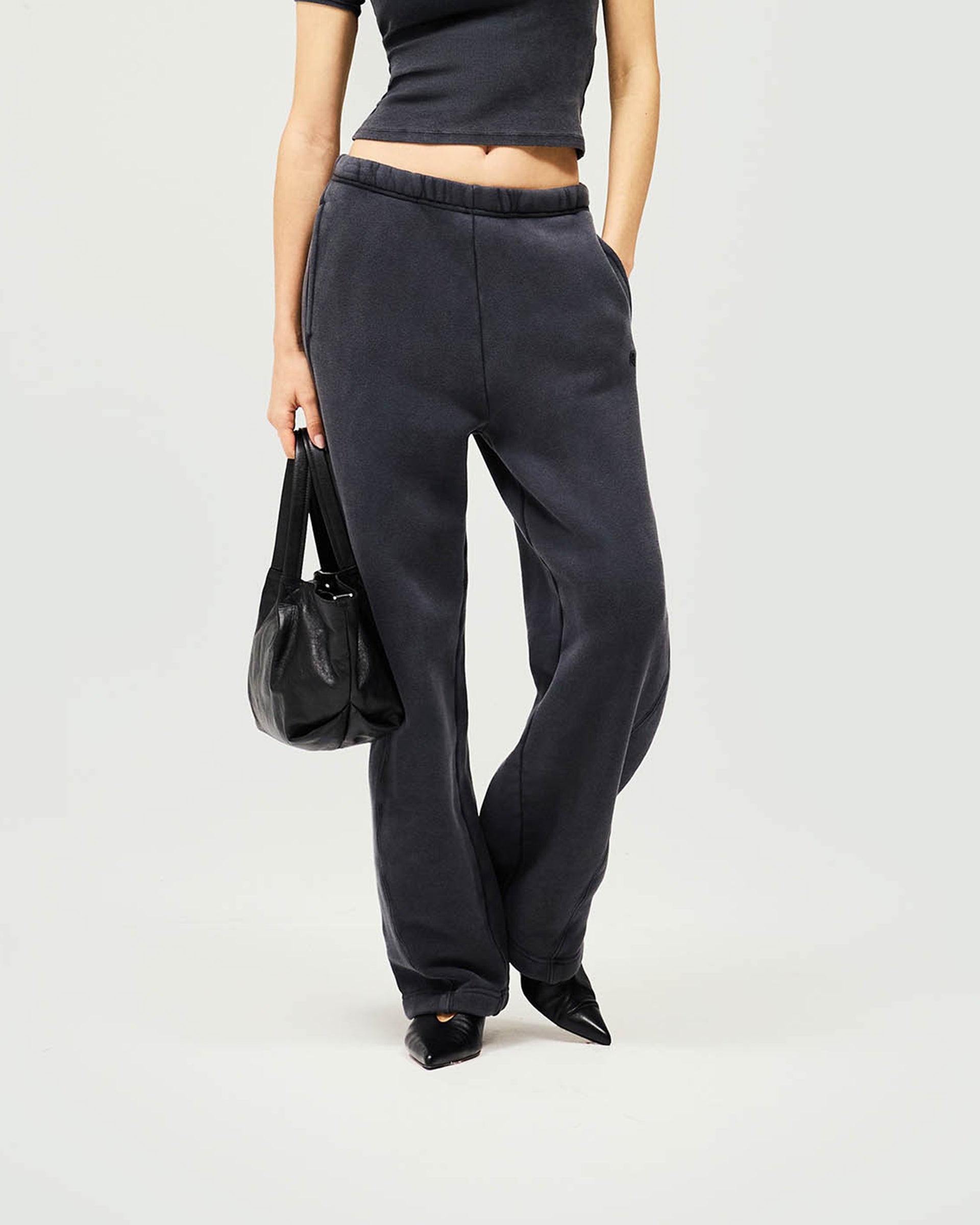 Back product image of womens black jogger on a plain white background | Initial Twisted Seam Jogger in Washed Black | Sweat trousers with elasticised waist and internal drawcord | Womens Initial Bottoms | Represent Clo