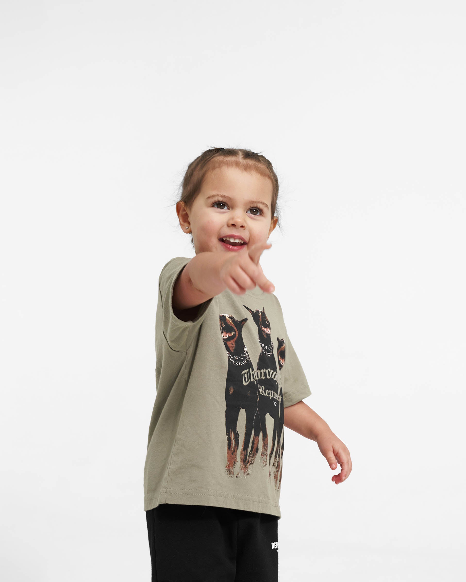 Back product image of a kids khaki t-shirt on a plain white background | Mini Thoroughbred T-Shirt in Khaki | Slightly oversized children's t-shirt with graphic | Mini T-Shirts | Represent Clo