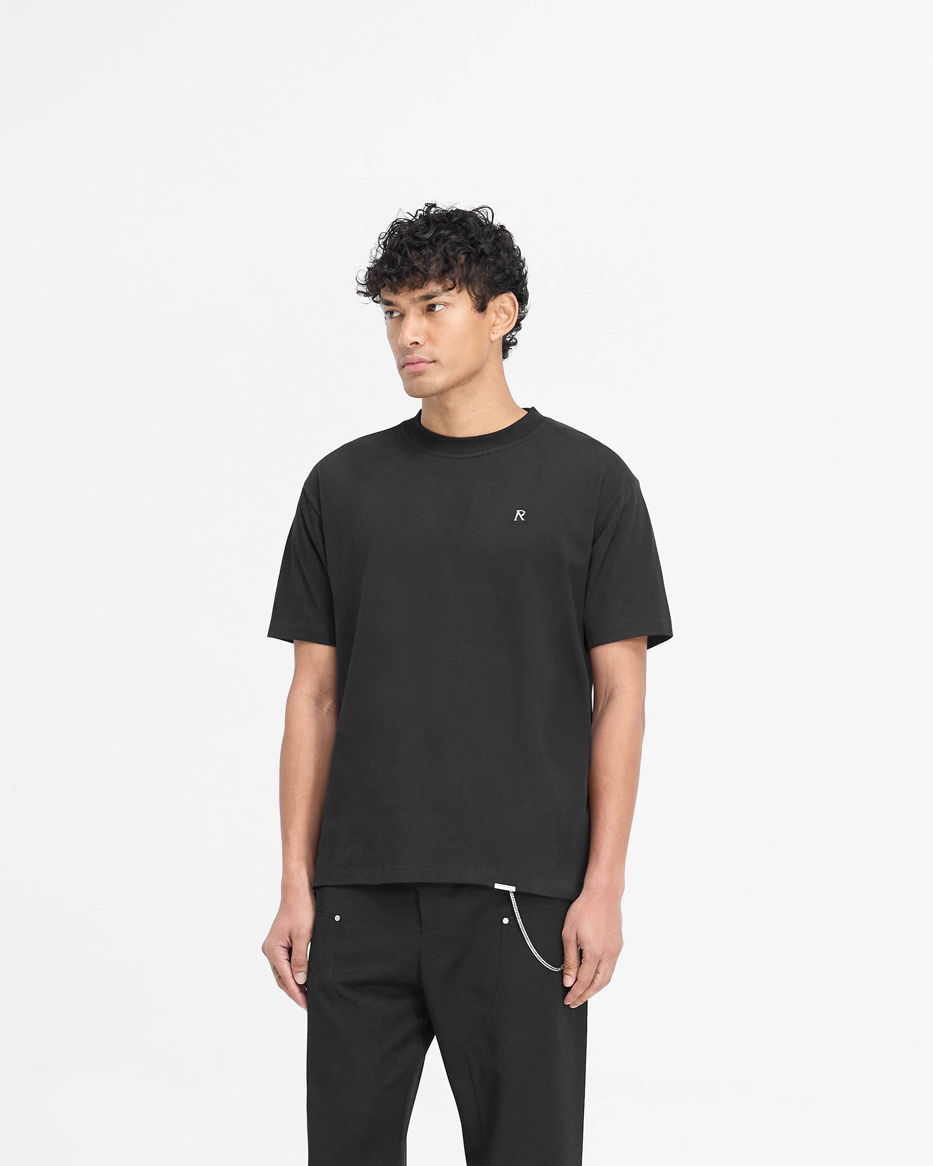 Back product image of a mens black t-shirt on a plain white background | Metal Initial R T-Shirt in Jet Black | Jersey cotton t-shirt with metal Initial logo | PRE SS25 T-Shirts | Represent Clo