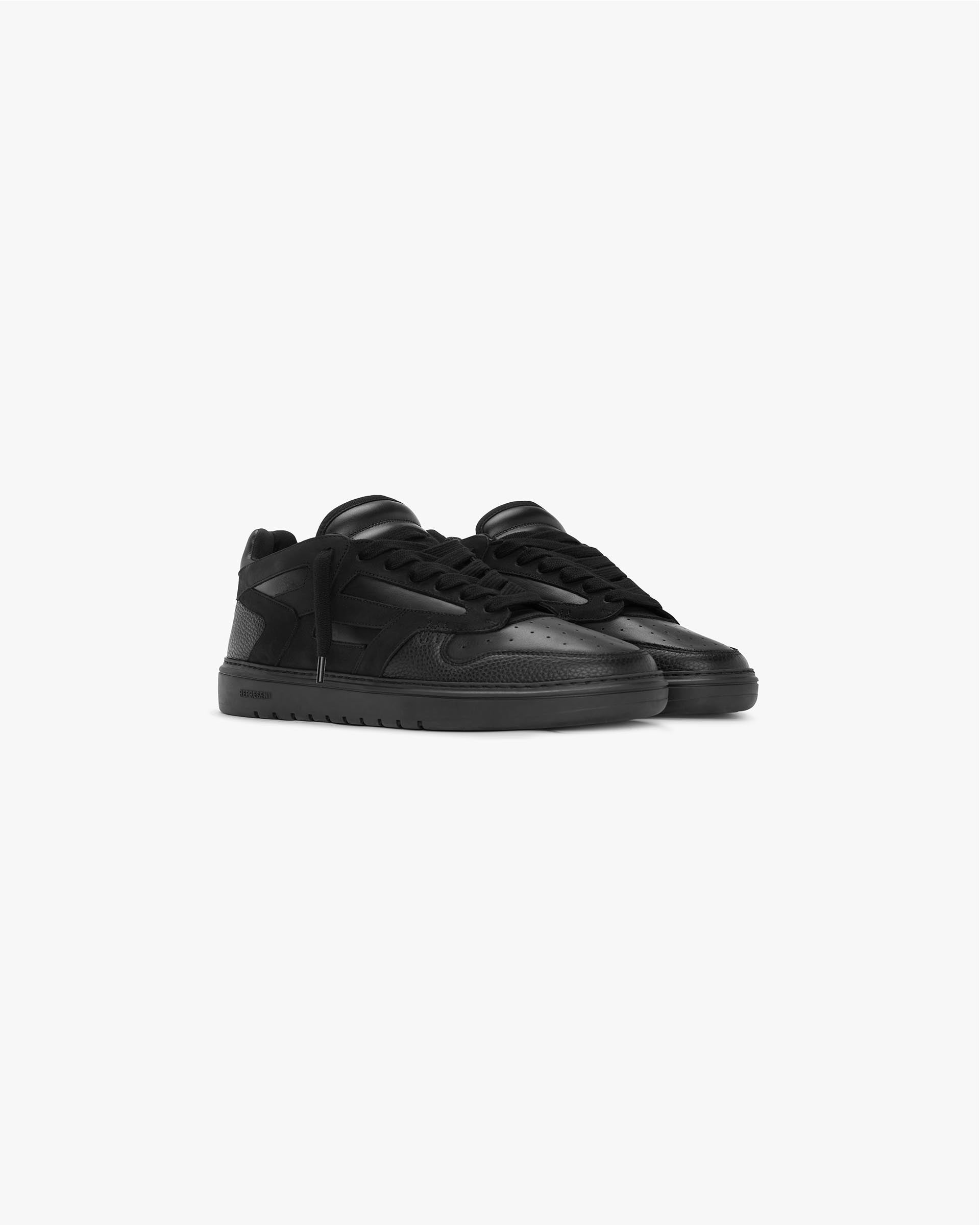 Back product image of a mens black sneaker on a plain white background | Reptor Low in Triple Black | Leather and suede low top sneaker | FW23 Footwear | Represent Clo