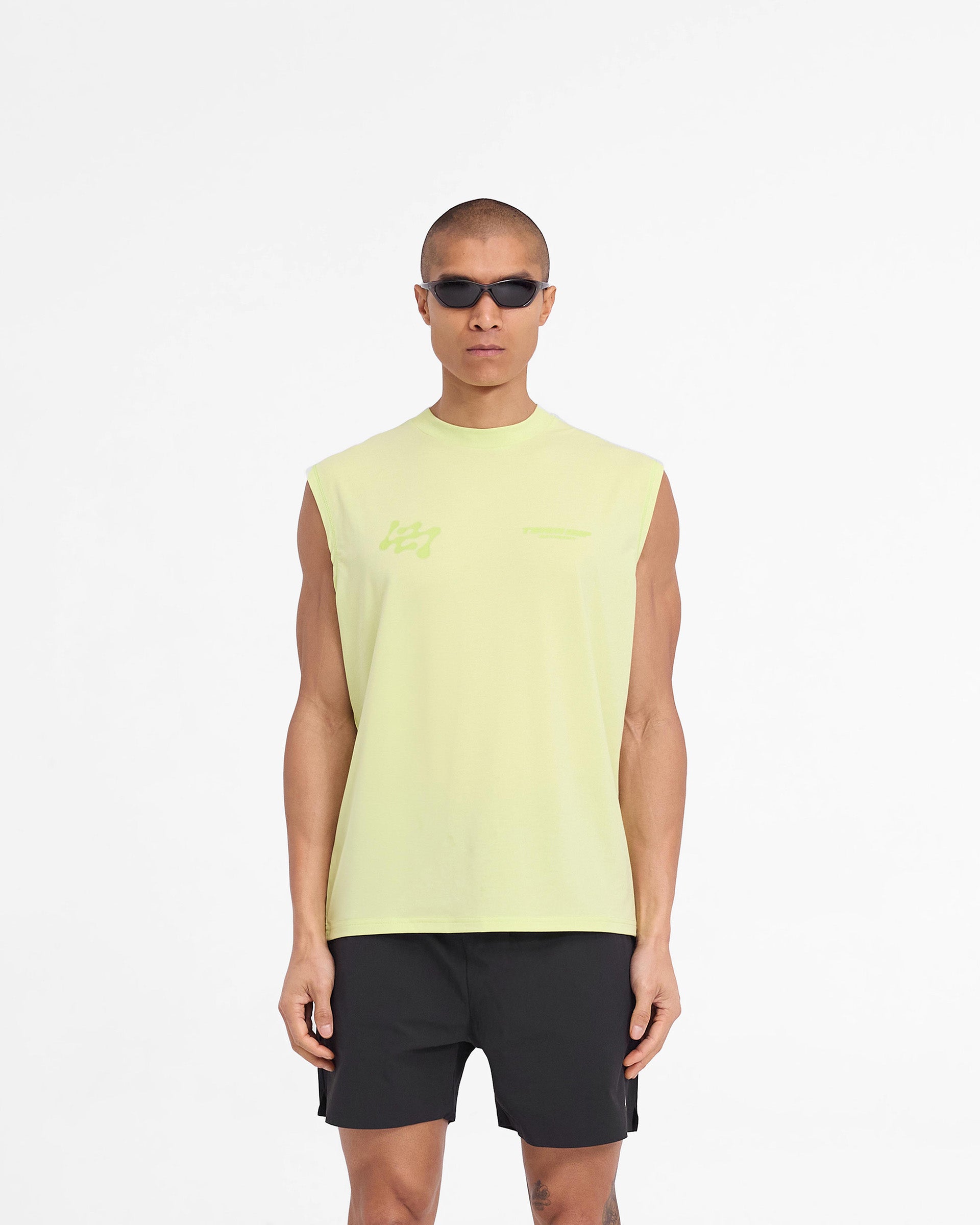 Man wearing an oversized lime tank top on a plain white background | 247 Future Terrains Oversized Tank in Shadow Lime | Quick drying lightweight tank top with Drirelease fabric | 247 T-Shirts | Represent Clo
