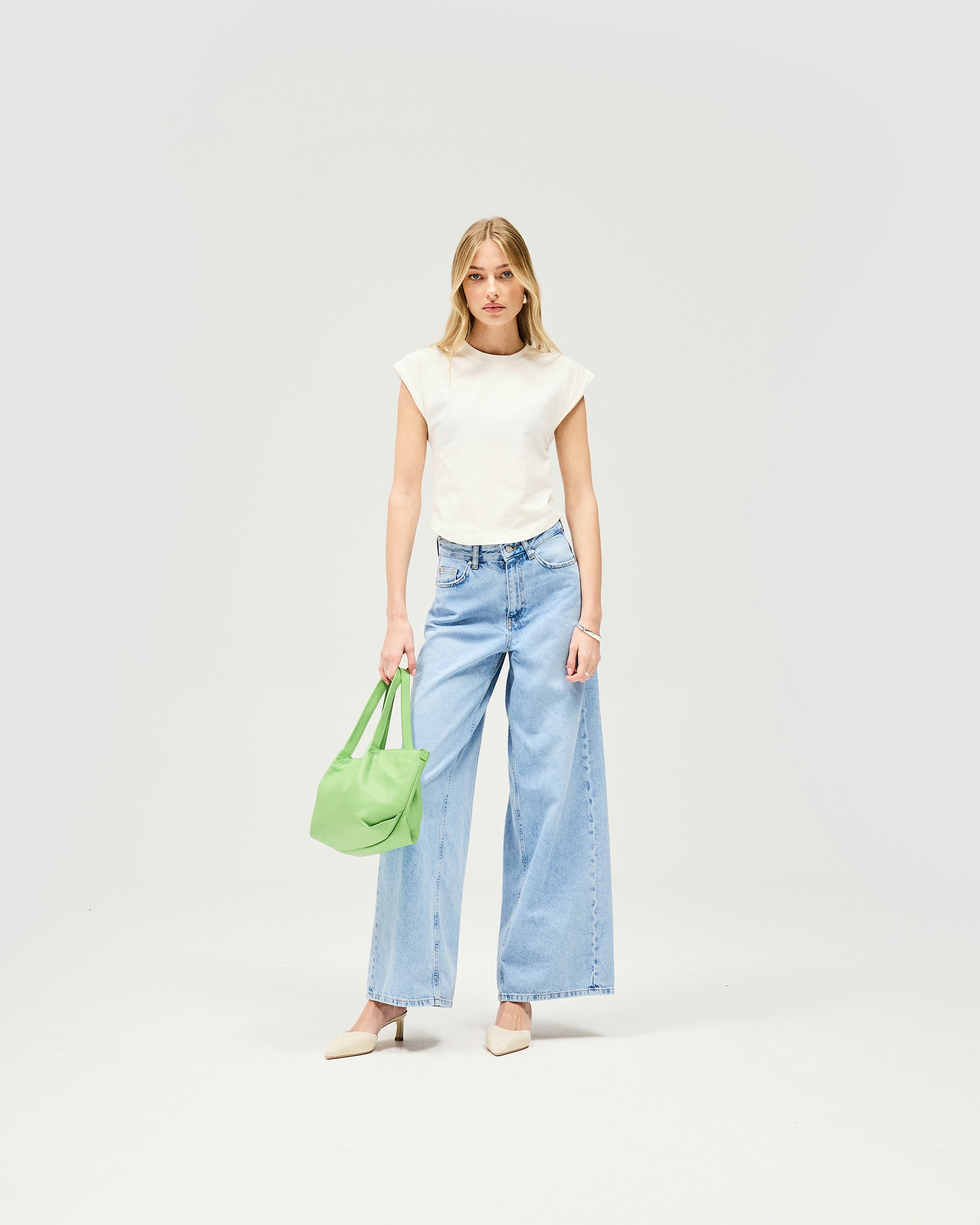 Back product image of a womens blue jeans on a plain white background | Mid Rise Wide Leg Jean in Washed Blue | Wide leg jeans with leather branded patch at back | Womens SS25 Jeans | Represent Clo