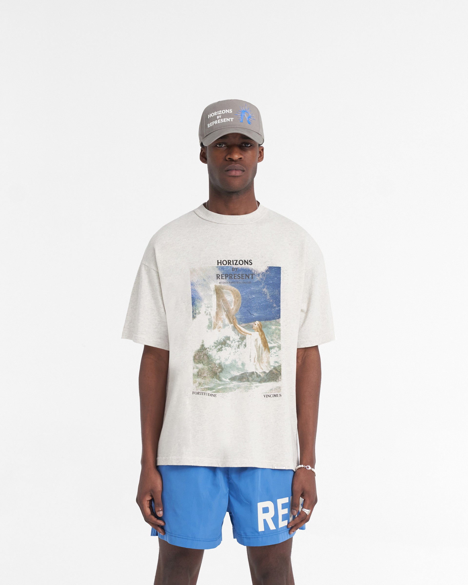 Man wearing a cream t-shirt on a plain white background | Higher Truth T-Shirt in Cream Marl | Oversized t-shirt with Higher Truth graphic | SS24 T-Shirts | Represent Clo