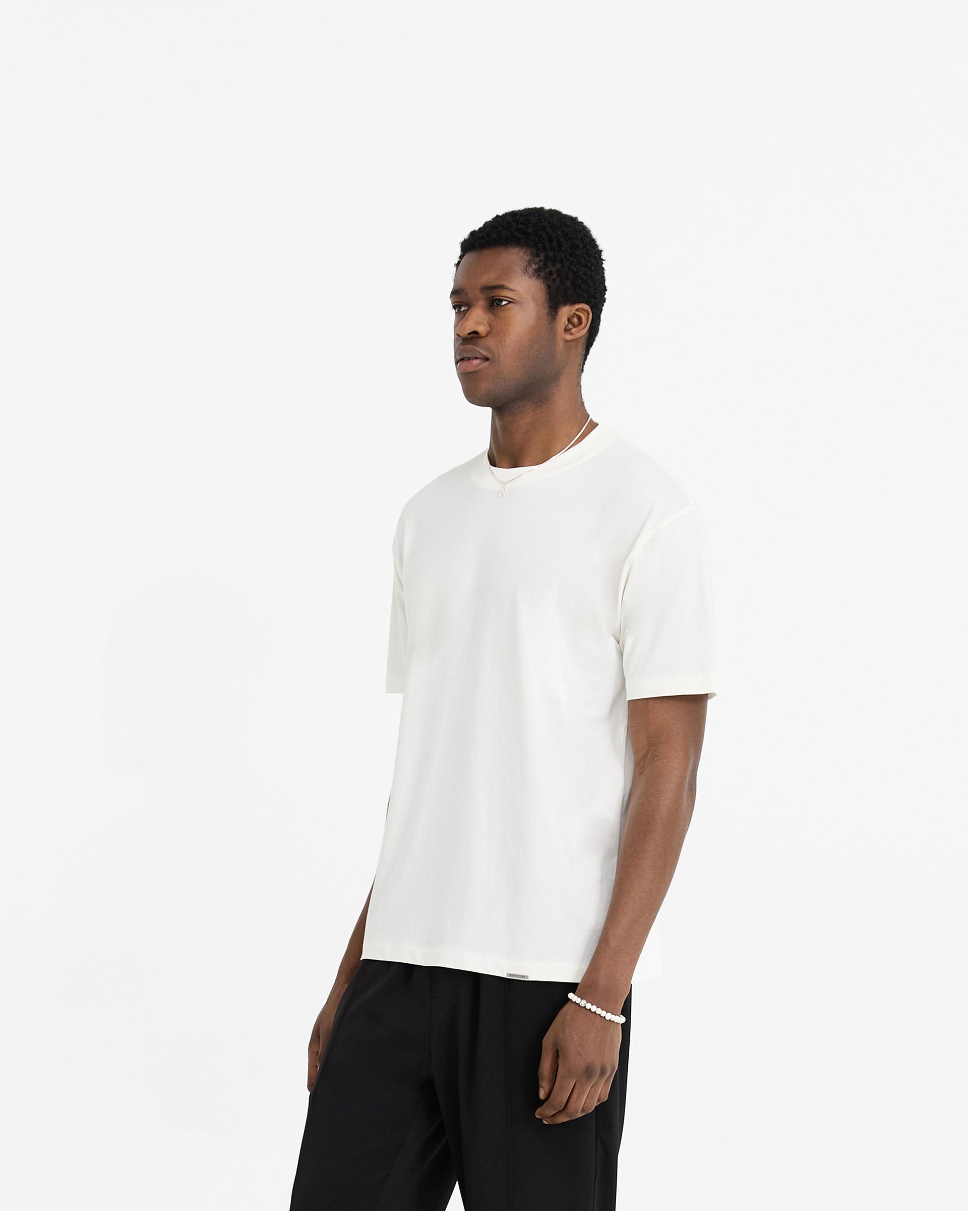 Back product image of a mens white t-shirt on a plain white background | Initial T-Shirt in Flat White | T-shirt with ribbed collar and embroidered details | Initial T-Shirts | Represent Clo