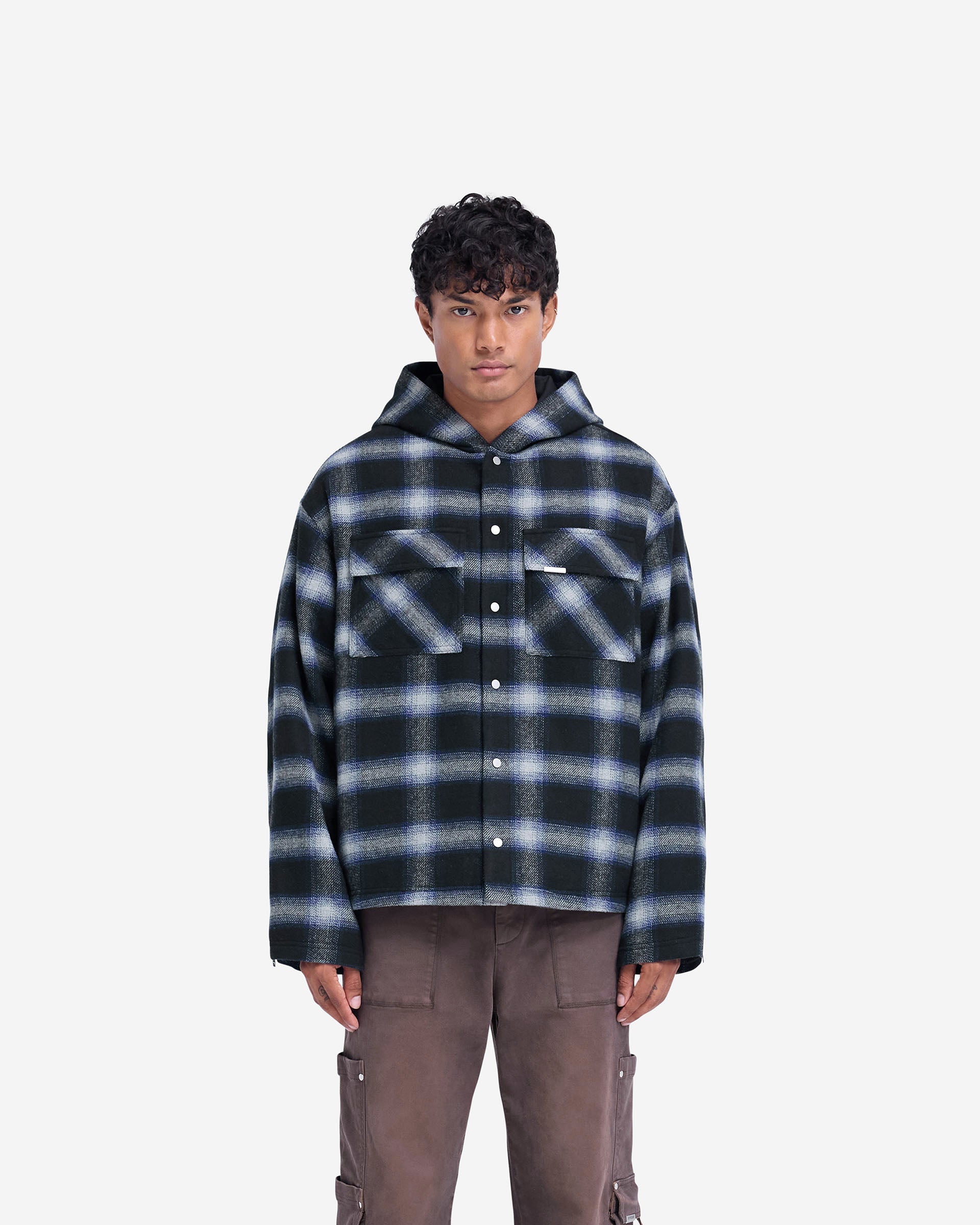 Man wearing a navy overshirt on a plain white background | Hooded Overshirt in Midnight Navy | Slightly oversized fit shirt with flap pockets | FW24 Shirts | Represent Clo