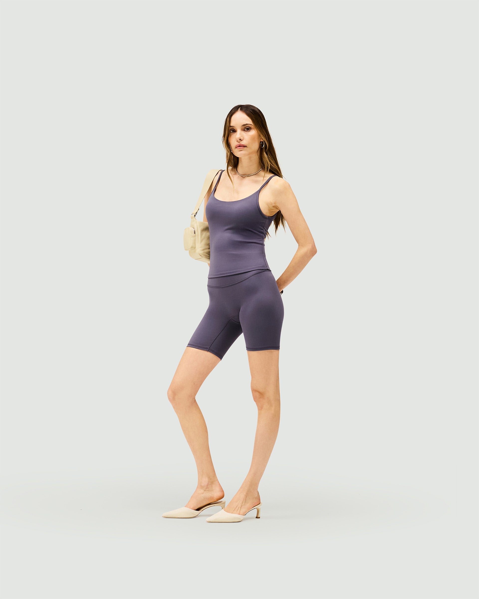Woman wearing a grey cami top on a plain white background | Owners Club Cami Top in Grey | Strappy cami top with built-in bra | Womens Tops | Represent Clo