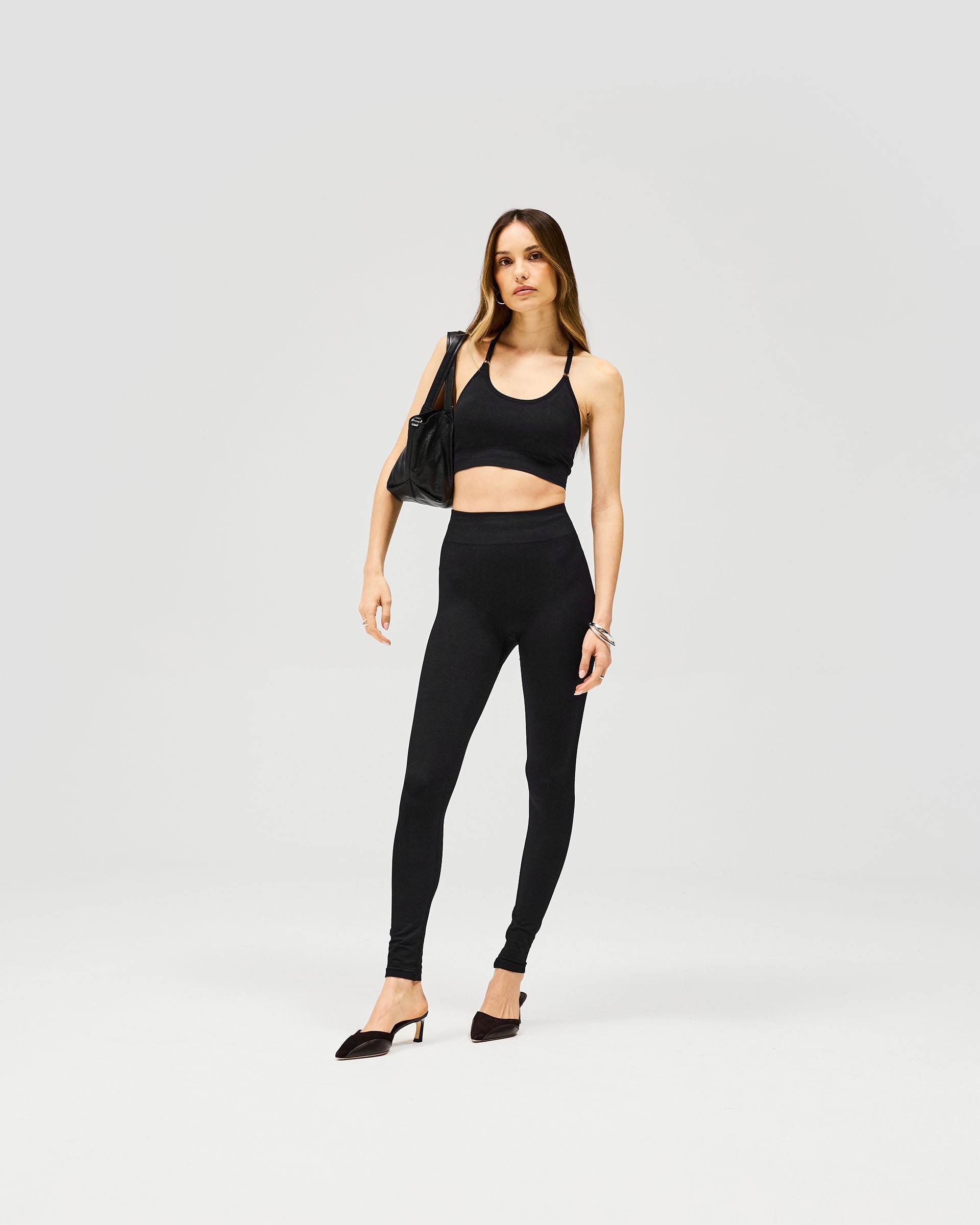 Back product image of womens black leggings on a plain white background | Owners Club Contour Seamless Legging in Jet Black | High waisted leggings with discreet contouring | Womens Owners Club Bottoms | Represent Clo