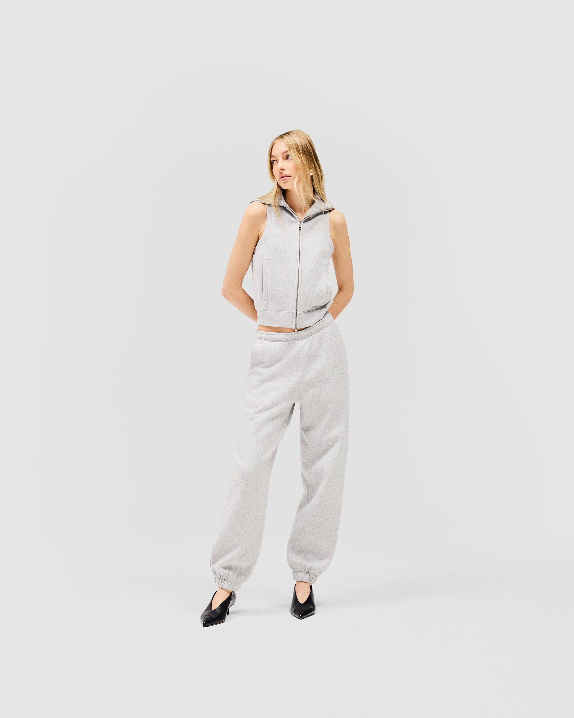Woman wearing a grey gilet on a plain white background | Owners Club Gilet in Grey Marl | Slim fit brushed cotton gilet with double zipper | Womens Owners Club Outerwear | Represent Clo