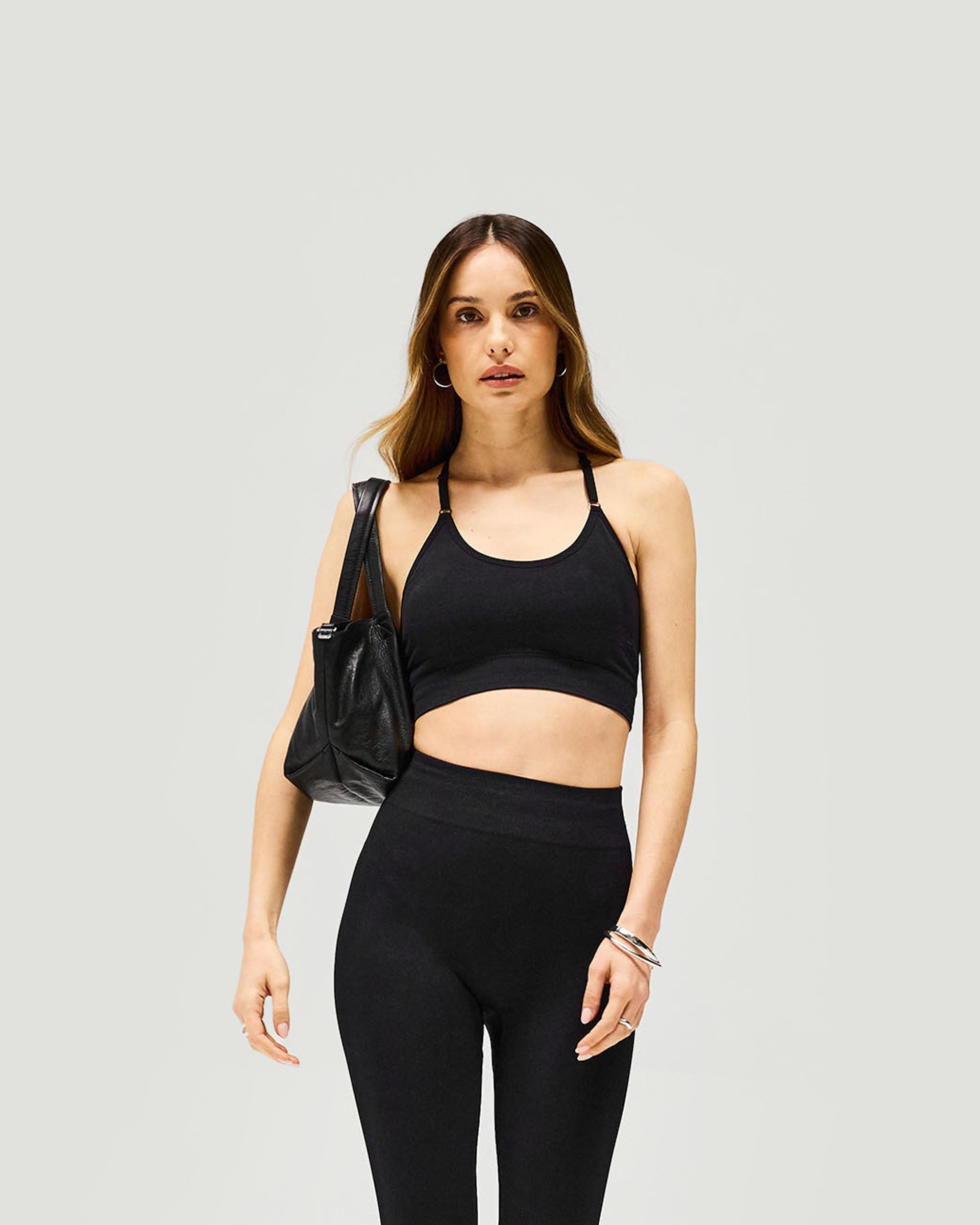 Back product image of a womens black bra on a plain white background | Owners Club Seamless Low Impact Bra in Jet Black | Seamless bra with t-bar back and adjustable straps | Womens Owners Club Tops | Represent Clo