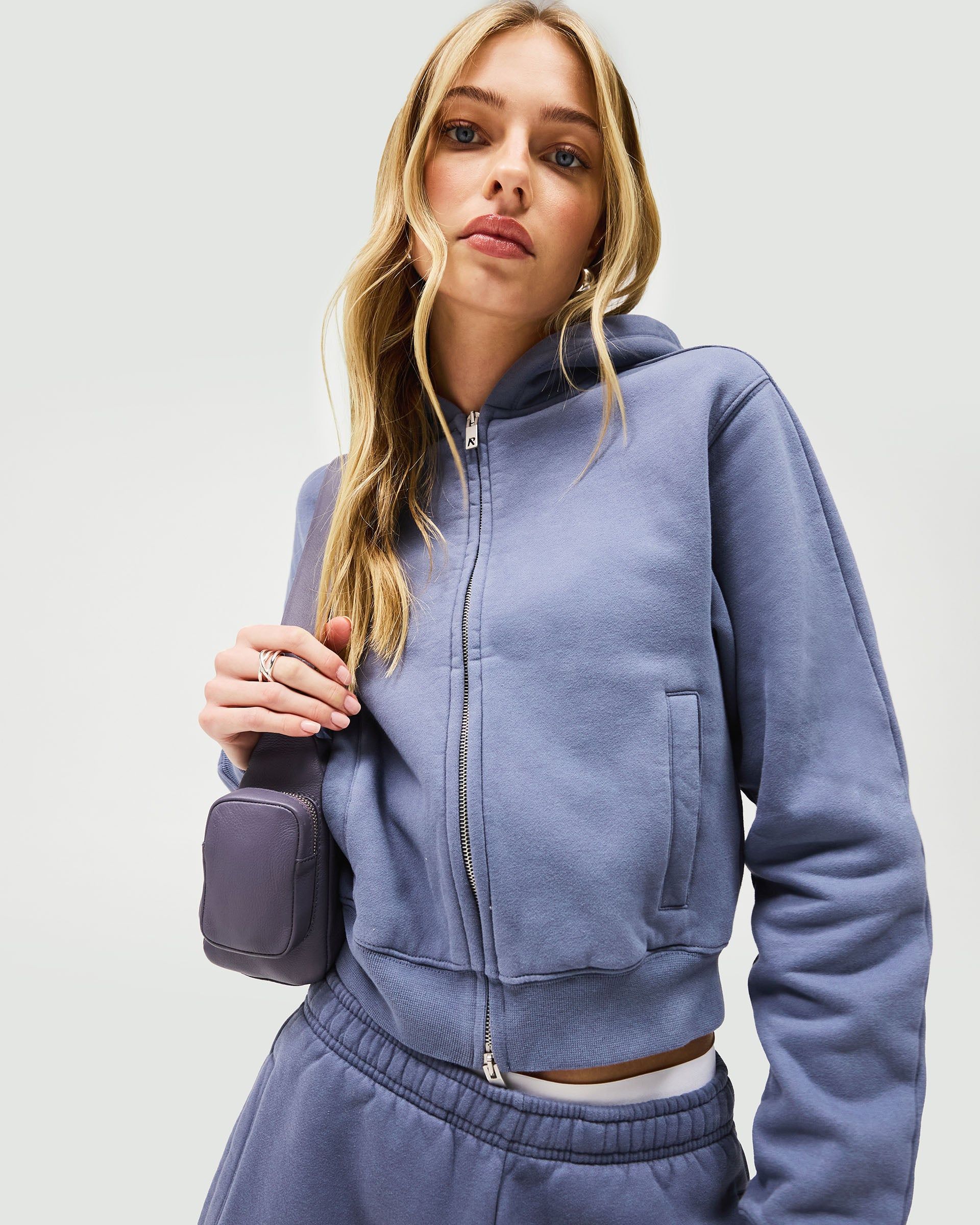 Back product image of a womens blue zip hoodie on a plain white background | Owners Club Slim Zip Hoodie in Steel Blue | Slim fit cropped hoodie with metal zipper | Womens Owners Club Hoodies | Represent Clo