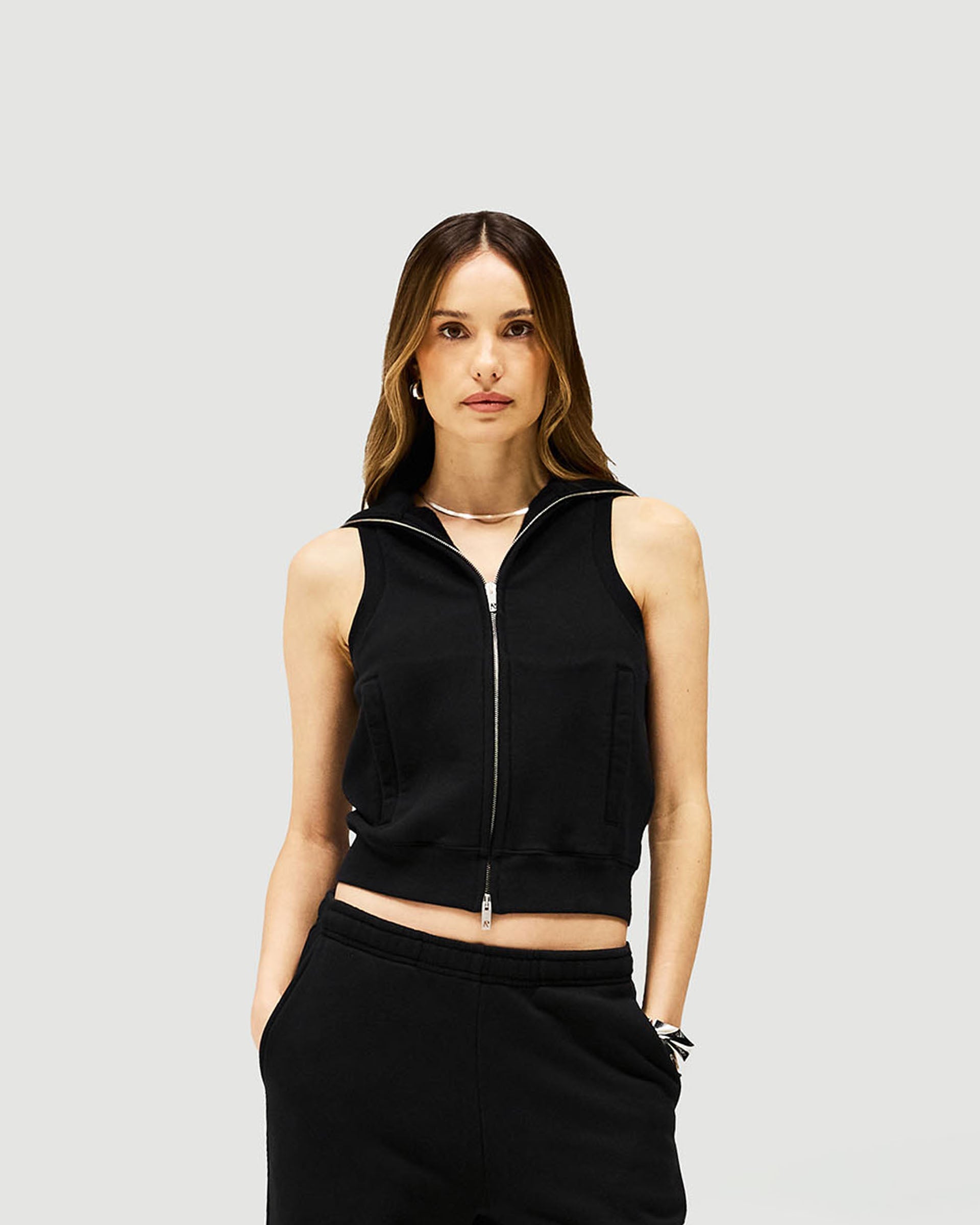 Woman wearing a black gilet on a plain white background | Owners Club Gilet in Jet Black | Slim fit gilet with double ended metal zipper | Womens Owners Club Outerwear | Represent Clo