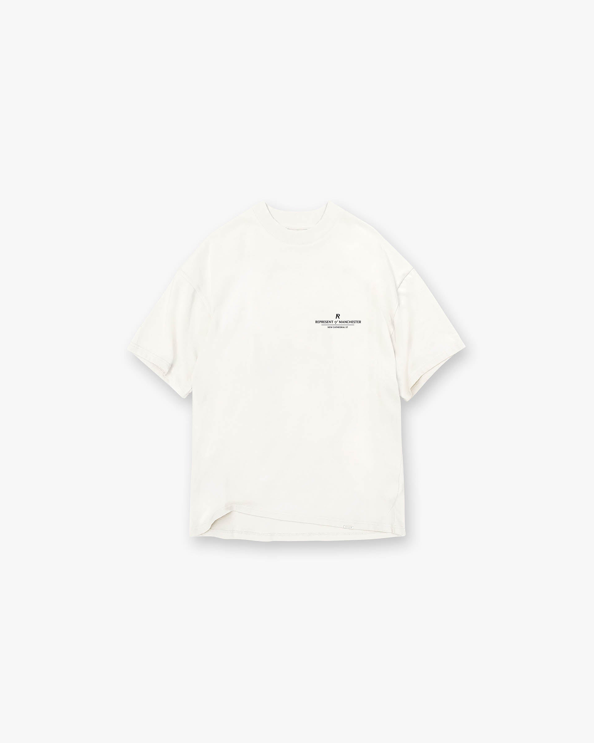 Front product image of a mens white t-shirt on a plain white background | Manchester Store T-Shirt in Flat White | Premium cotton t-shirt with exclusive branding | Exclusives T-Shirts | Represent Clo