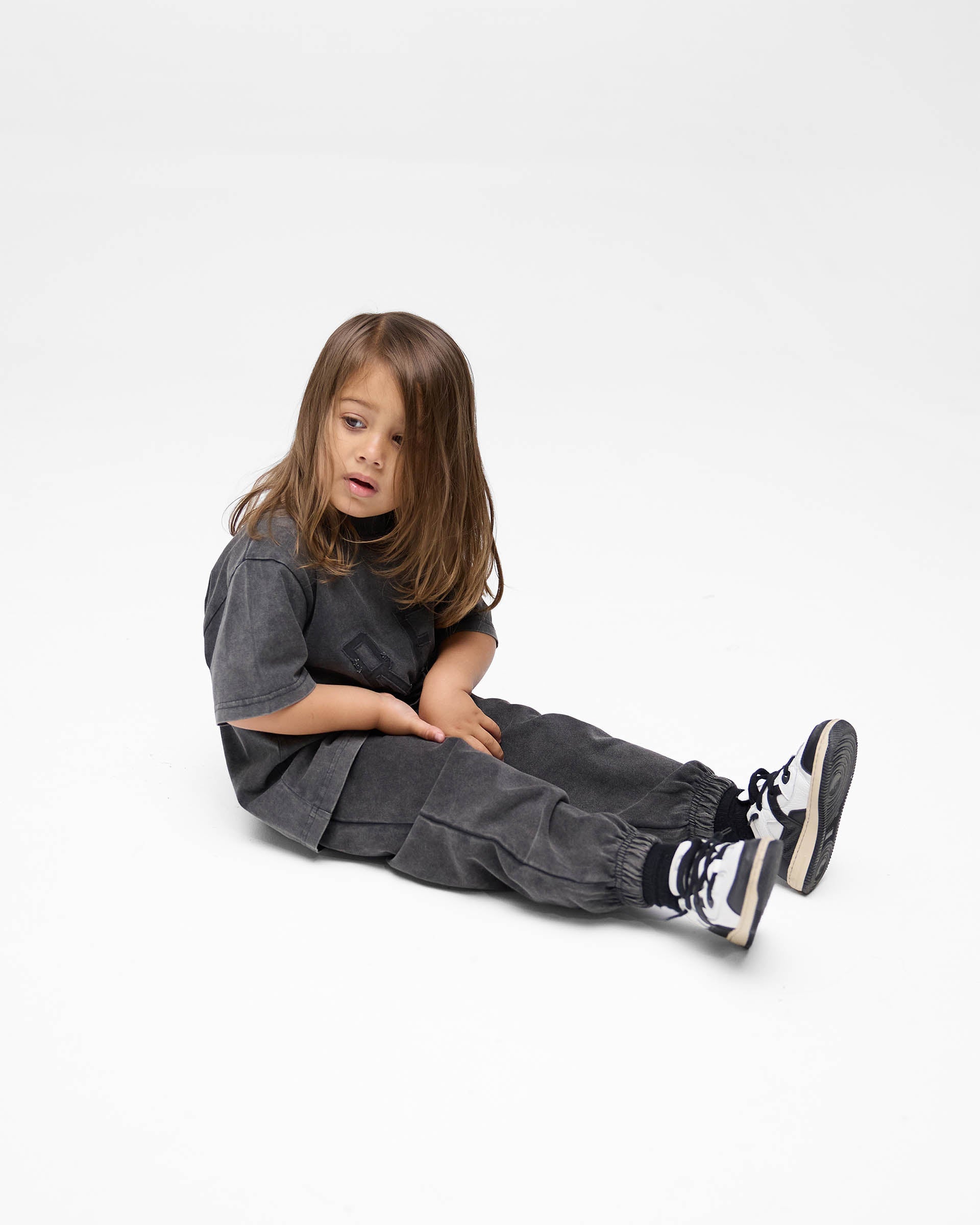 Back product image of a childs black t-shirt on a plain white background | Mini Rep Applique T-Shirt in Vintage Black | Kids t-shirt with oversized fit | FW24 T-Shirts | Represent Clo