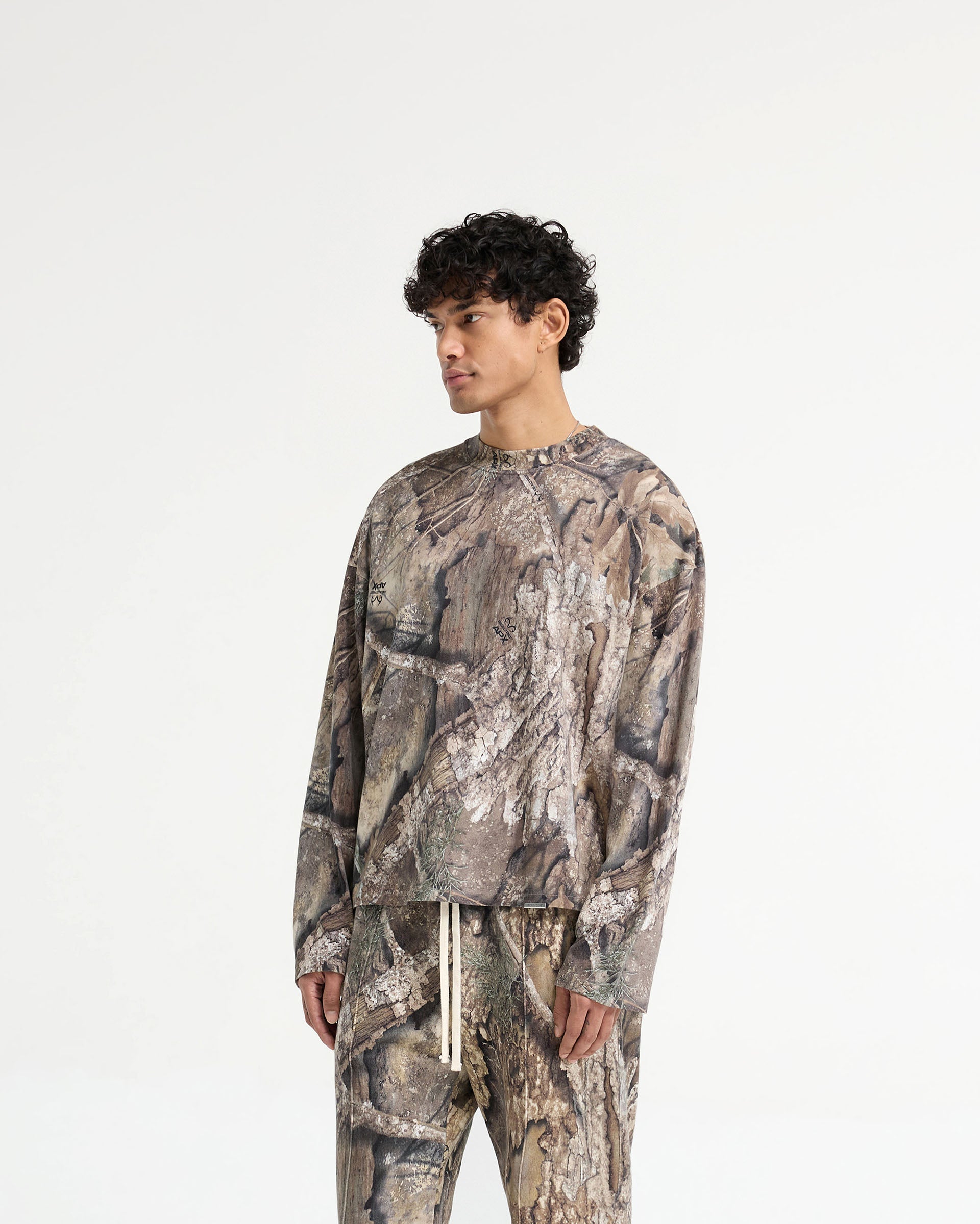 Back product image of a mens camo long sleeve t-shirt on a plain white background | Realtree Camo Long Sleeve T-Shirt in Camo | Medium weight jersey cotton long sleeve t-shirt with carbon finish | SS25 T-Shirts | Represent Clo