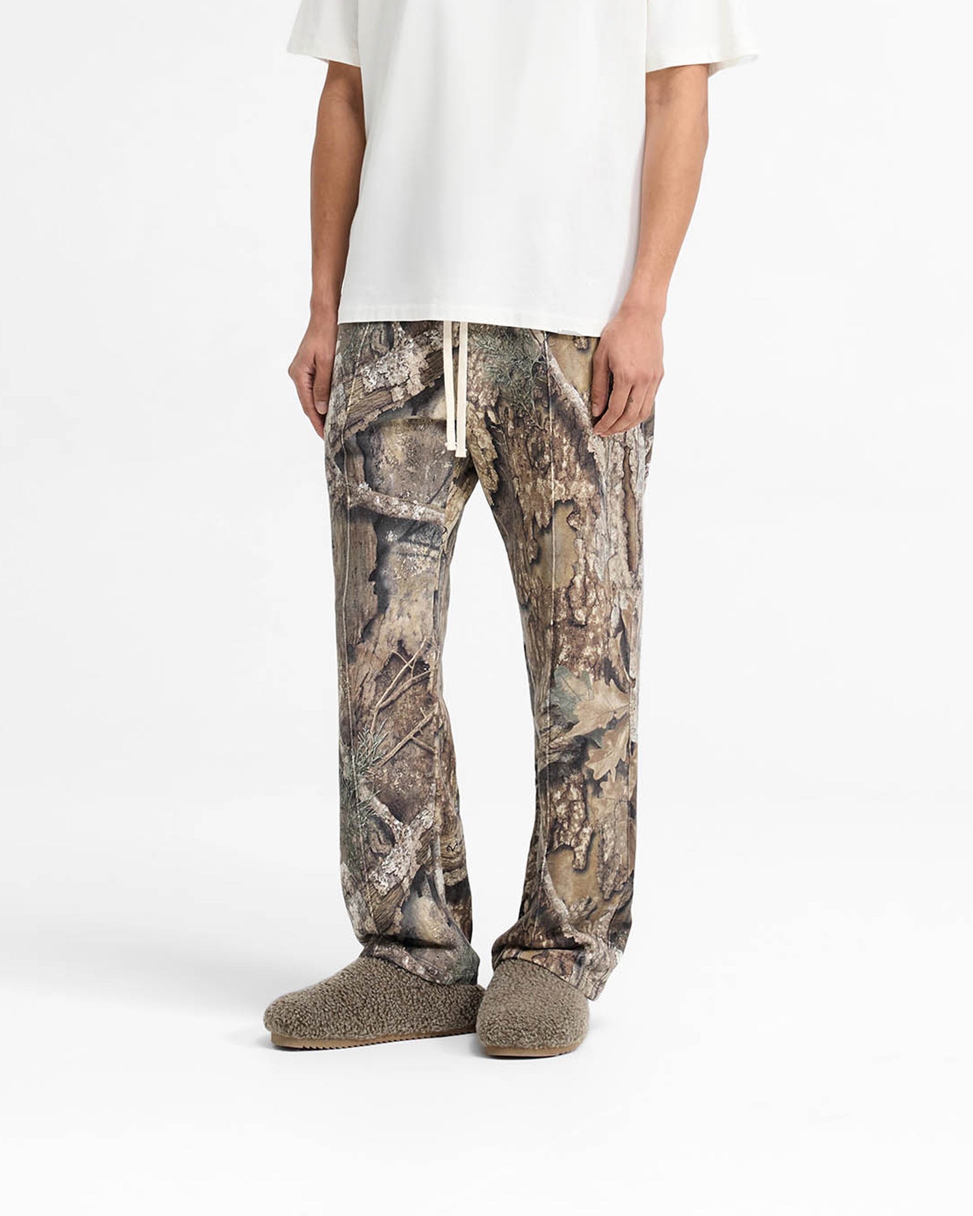 Back product image of mens camo pants on a plain white background | Realtree Camo Sweatpants in Camo | Wide leg sweatpants with pintuck detail and elasticated waistband | SS25 Pants | Represent Clo