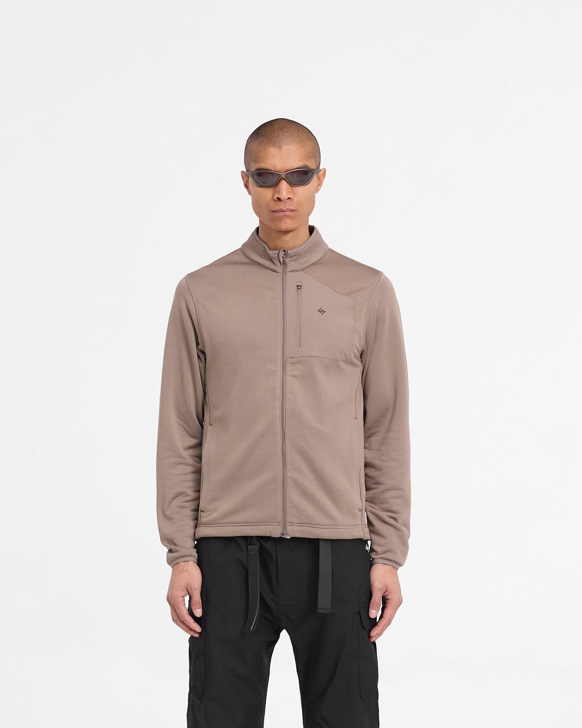 Man wearing an umber fleece jacket on a plain white background | 247 Full Zip Fleece in Umber | Fleece jacket with zip chest pocket and adjustable hem | 247 Outerwear | Represent Clo