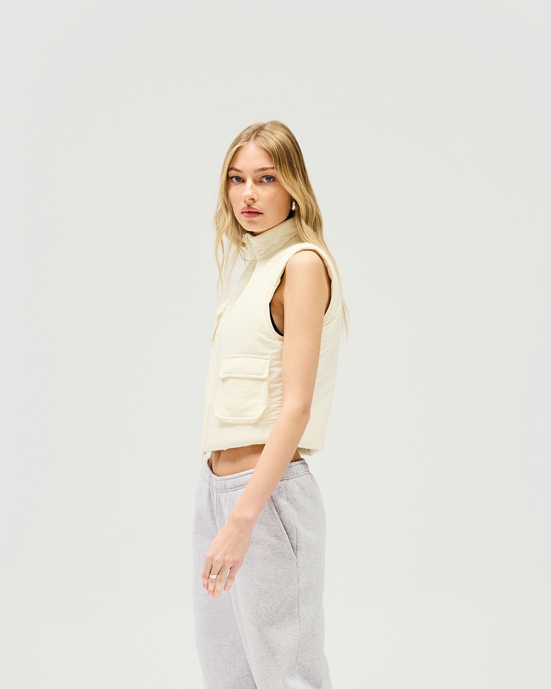 Back product image of a womens white gilet on a plain white background | Revolver Gilet in Warm White | Shrunken fit gilet with recycled down fill | SS25 Outerwear | Represent Clo
