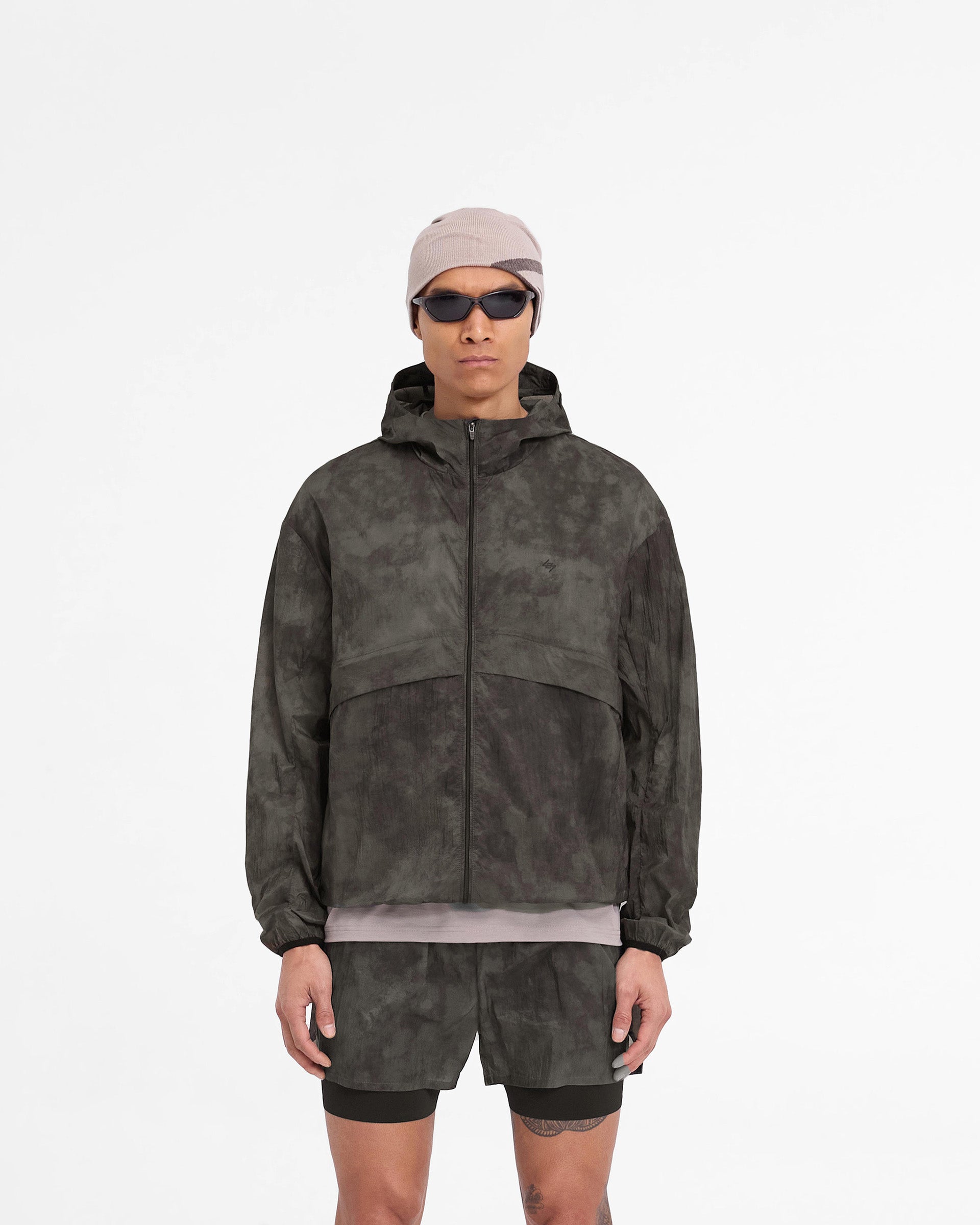 Man wearing a terrain hooded jacket on a plain white background | 247 Hooded Training Jacket in Terrain | Nylon training jacket with DWR coating | 247 Outerwear | Represent Clo