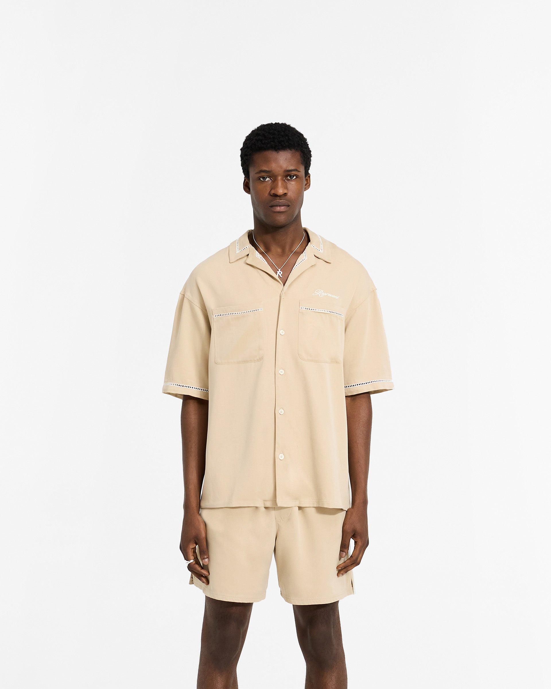 Man wearing a latte brown drapey shirt on a plain white background | Resort Shirt in Latte | Shirt with revere collar and chest pockets | SC24 Shirts | Represent Clo